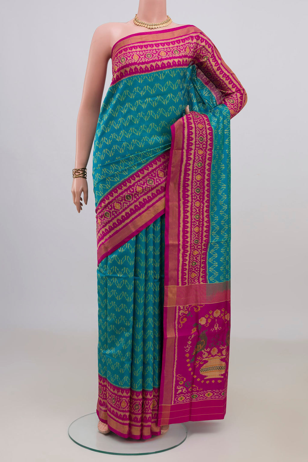Pure Silk Blue Rajkot Patola Saree with Ikat design on the body and Ikat Border.  displayed on a mannequin