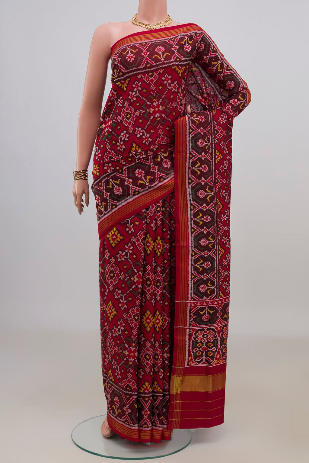 Pure Silk Maroon Rajkot Patola Saree with Ikat design on the body and Ikat Border.  displayed on a mannequin