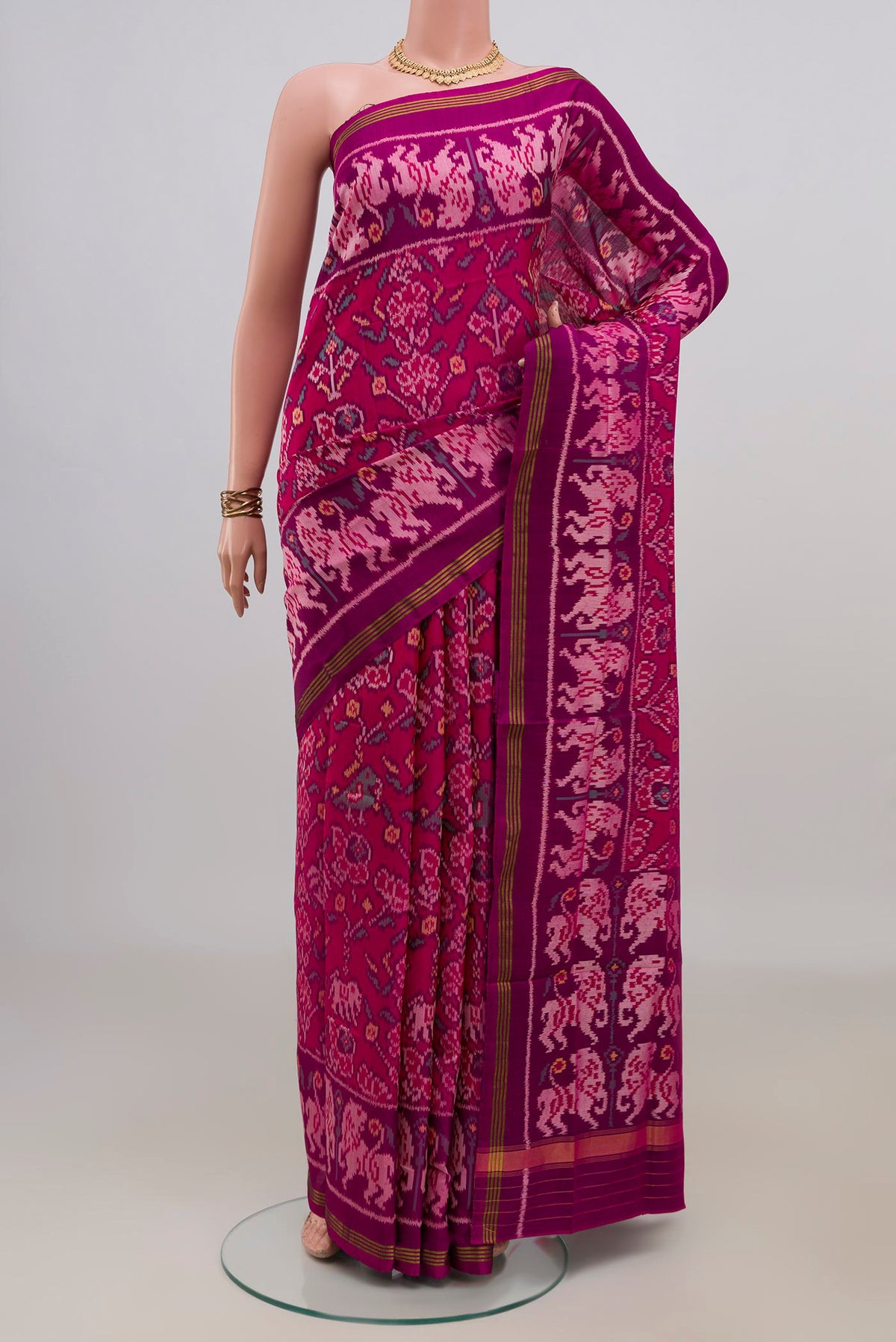 Pure Silk Pink Rajkot Patola Saree with Ikat design on the body and Ikat Border.  displayed on a mannequin