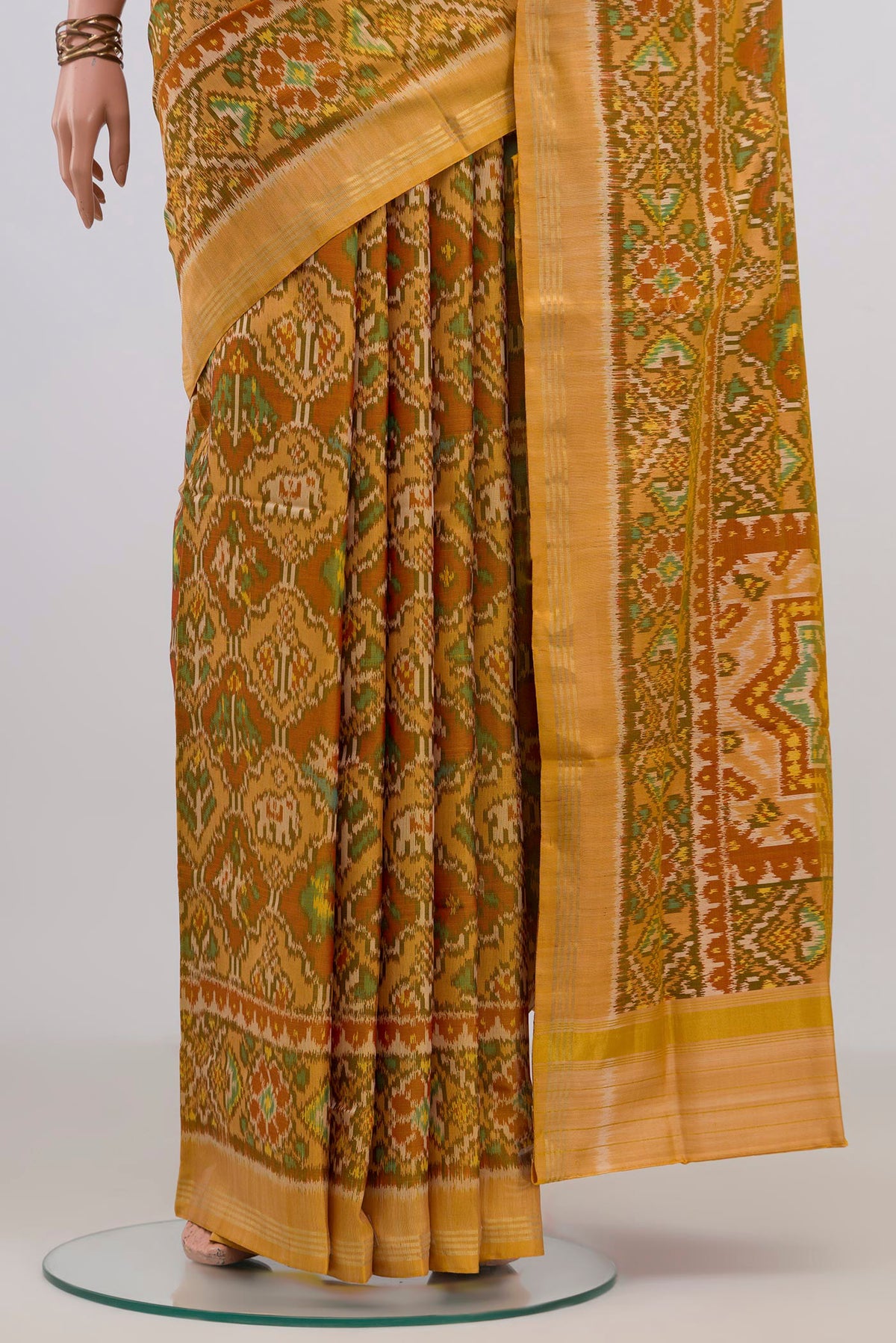 Pleats and pallu of Pure Silk Mustard Rajkot Patola Saree with Pure Ikat on the body and Thin Zari Line. 