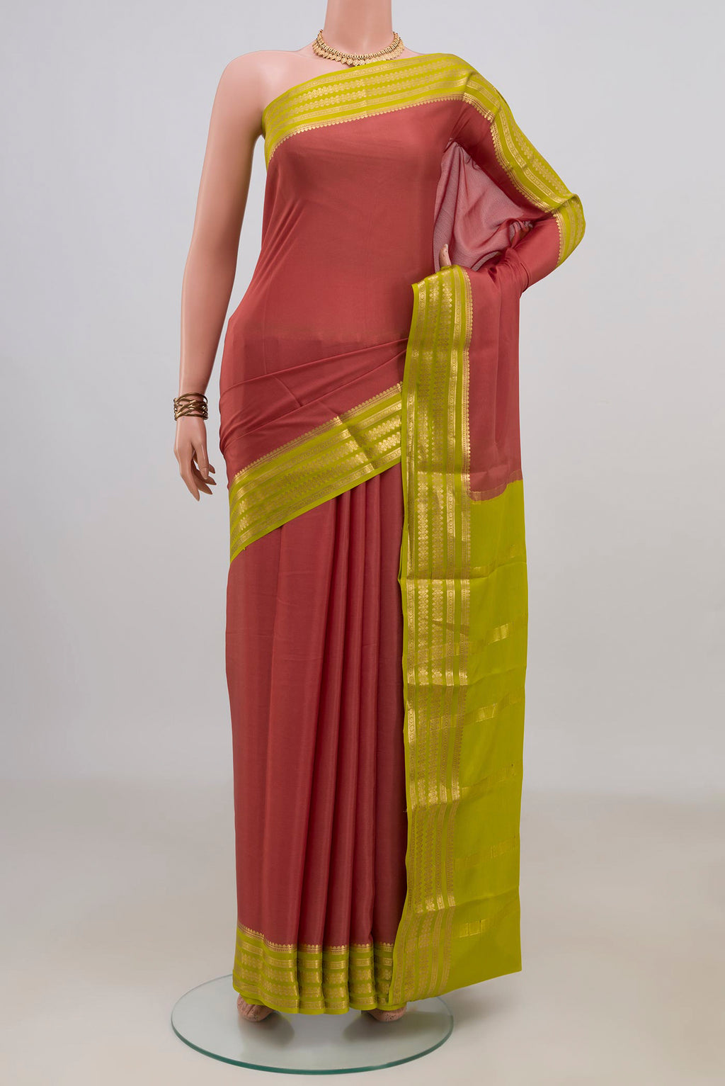 Coral Mysore Crepe Saree with Plain Body and Zari Border.  displayed on a mannequin