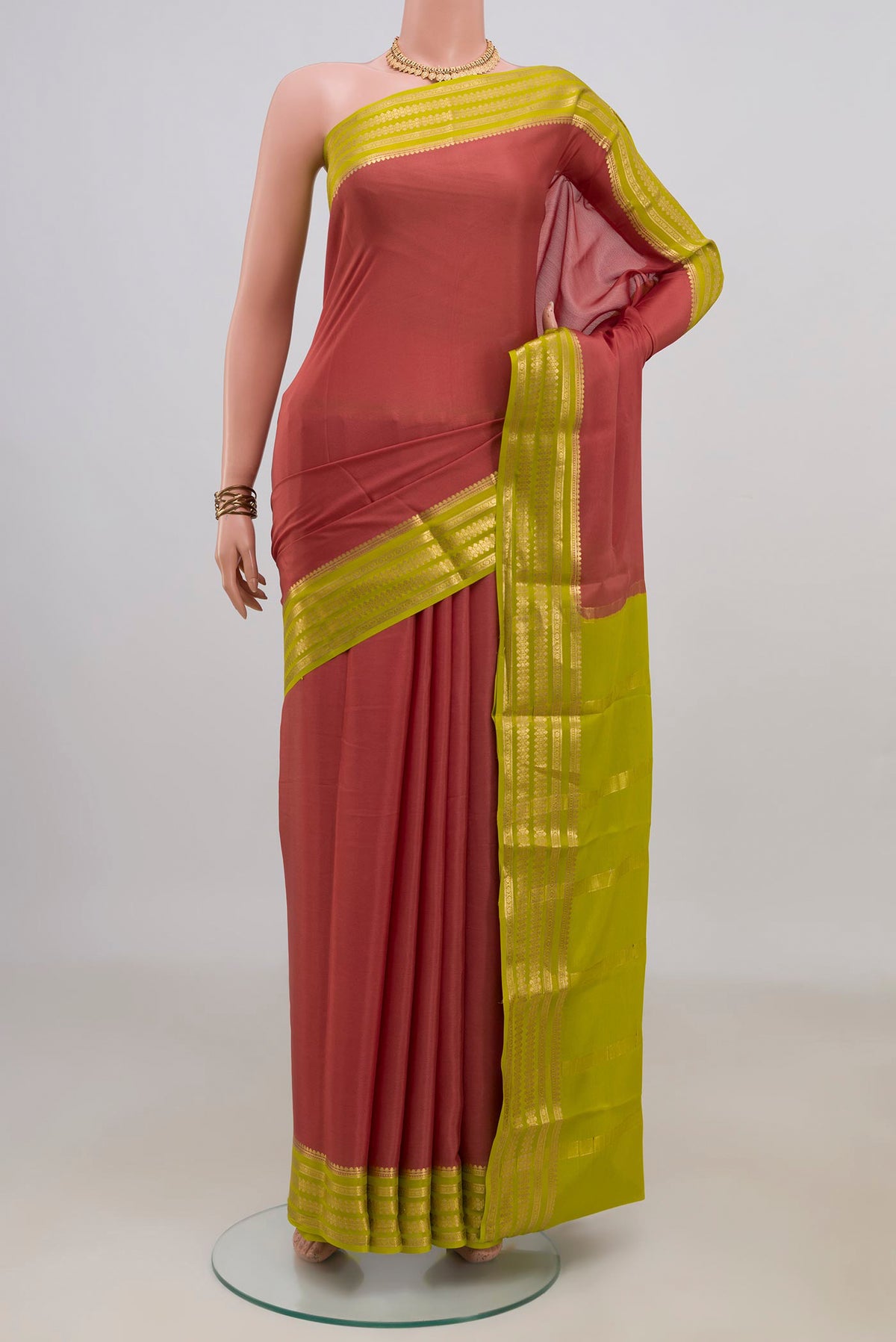 Coral Mysore Crepe Saree with Plain Body and Zari Border.  displayed on a mannequin