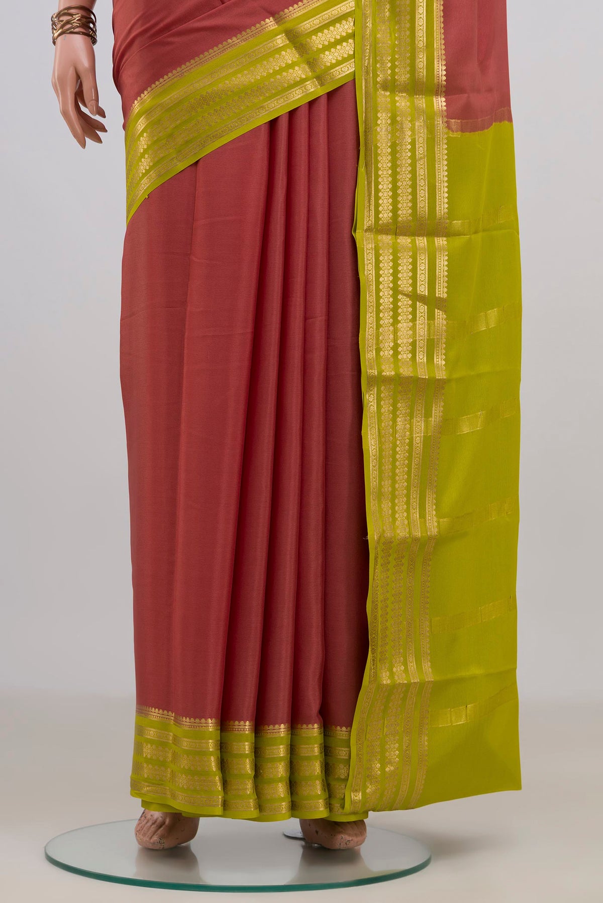 Pleats and pallu of Coral Mysore Crepe Saree with Plain Body and Zari Border. 