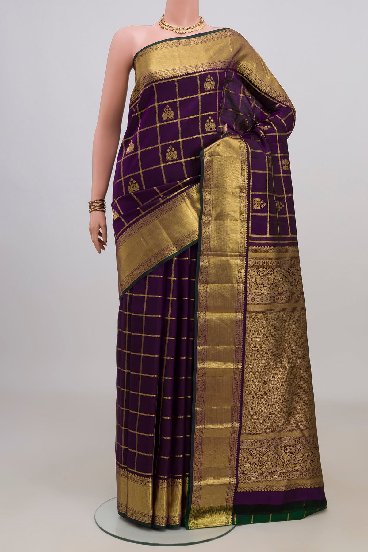 Pure Silk Purple Kanchipuram Saree with Checked design on the body and Zari Border.  displayed on a mannequin