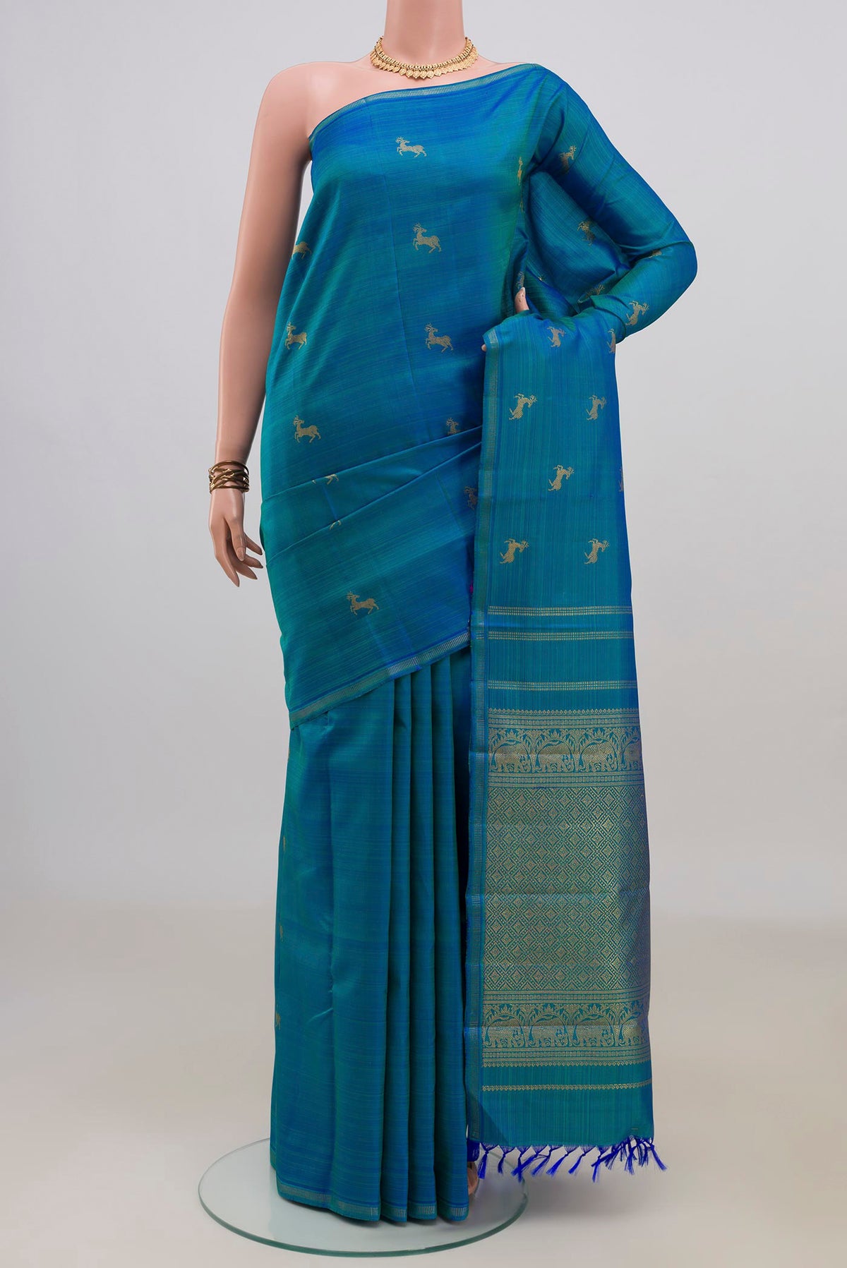 Pure Silk Pure Zari Blue Kanchipuram Saree with Zari Butta on the body and Thin Zari Line.  displayed on a mannequin