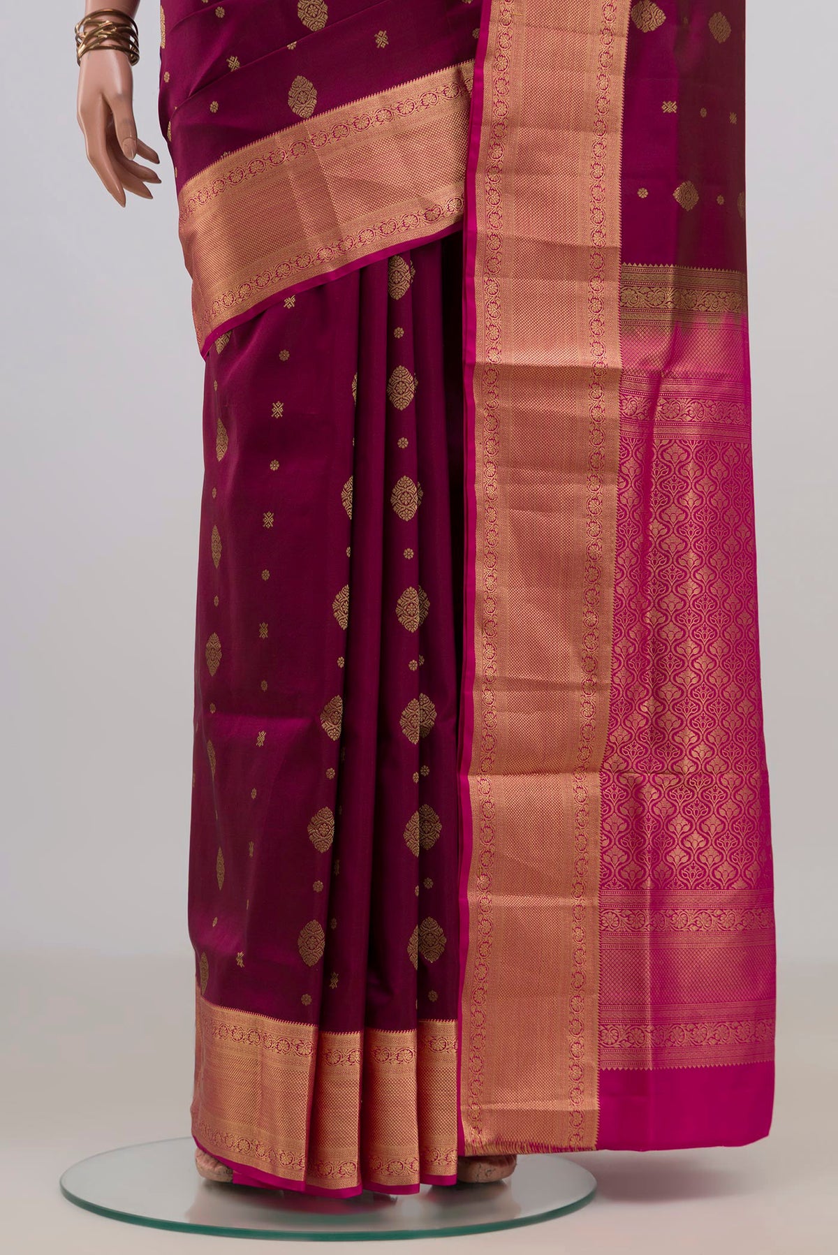 Pleats and pallu of Pure Silk Magenta Soft Saree with Zari Butta on the body and Zari Border. 
