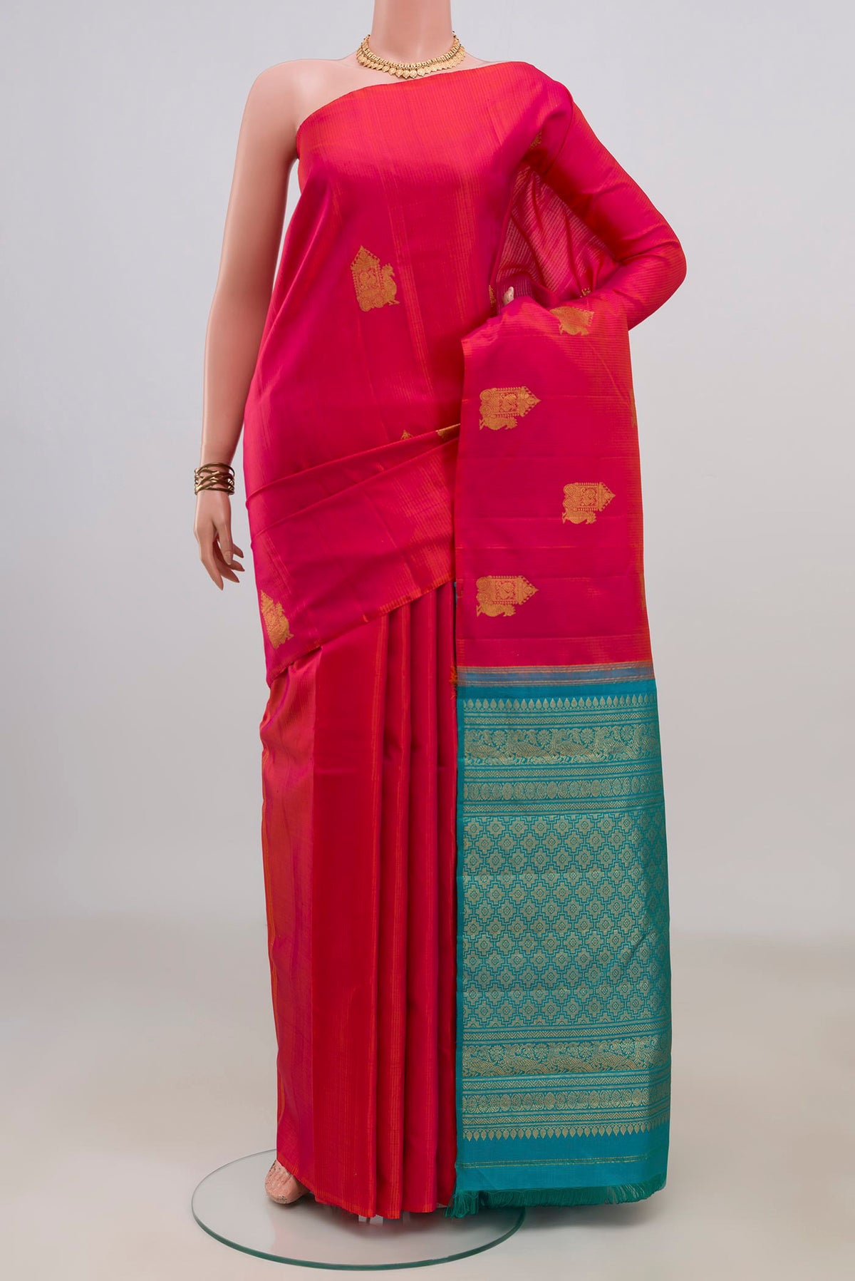 Pure Silk Pink Kanchipuram Saree with Zari Butta on the body and Without Border.  displayed on a mannequin