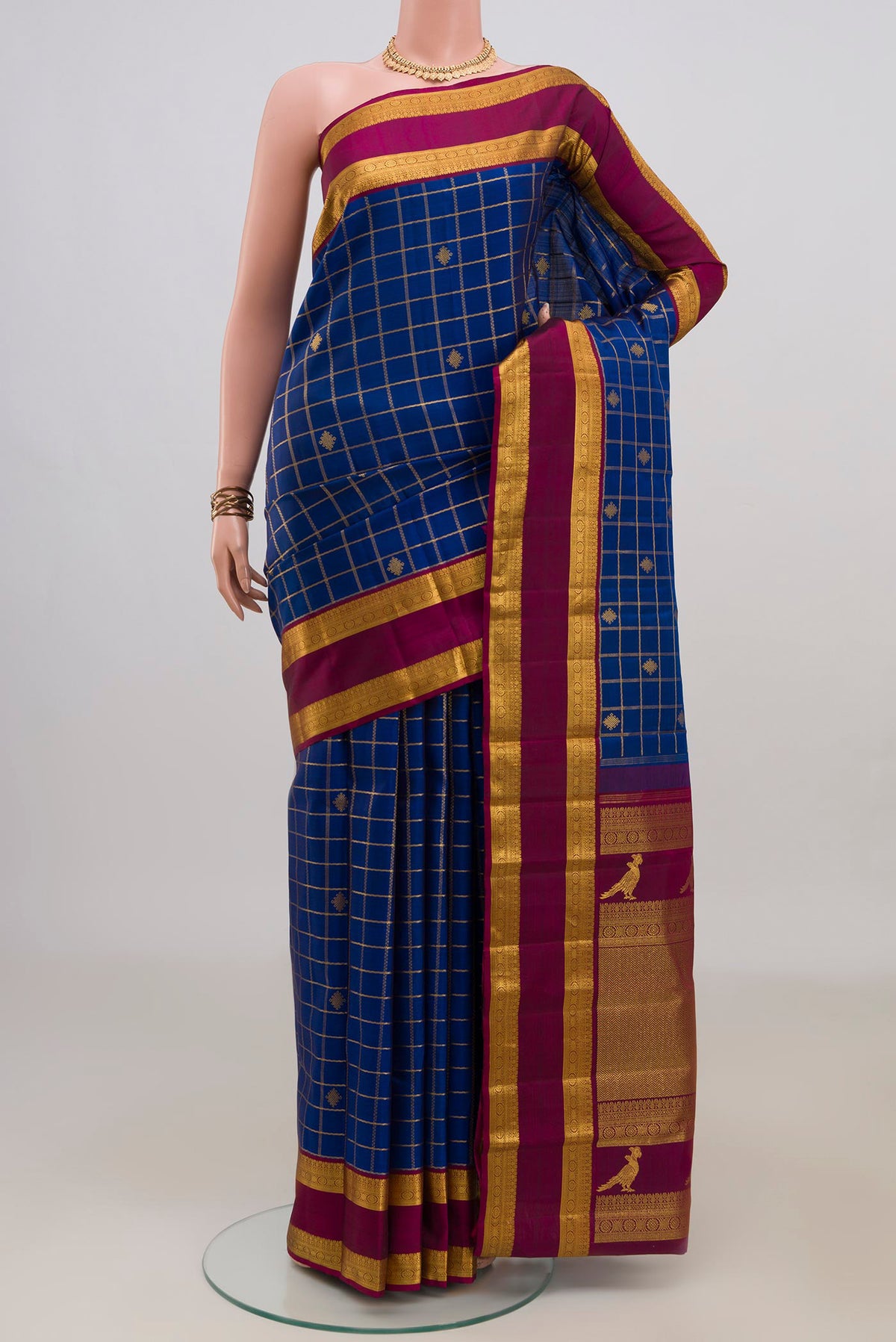 Pure Silk Blue Kanjivaram Saree with Checked design on the body and Zari Border.  displayed on a mannequin