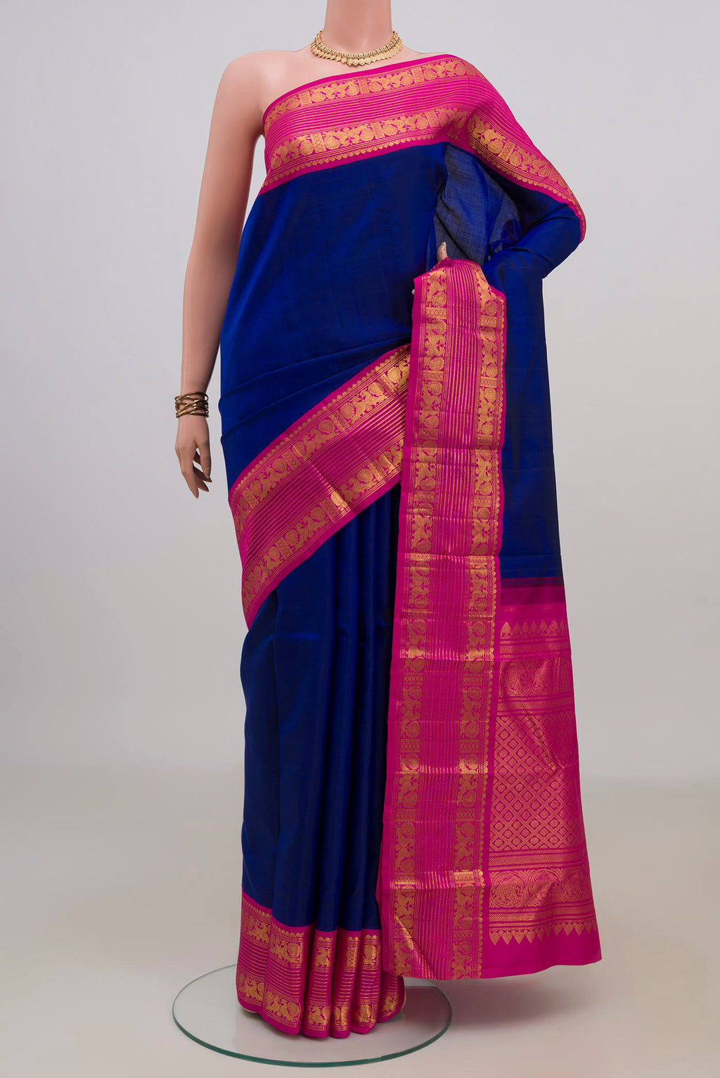 Pure Silk Blue Kanjivaram Saree with Plain Body and Zari Border.  displayed on a mannequin