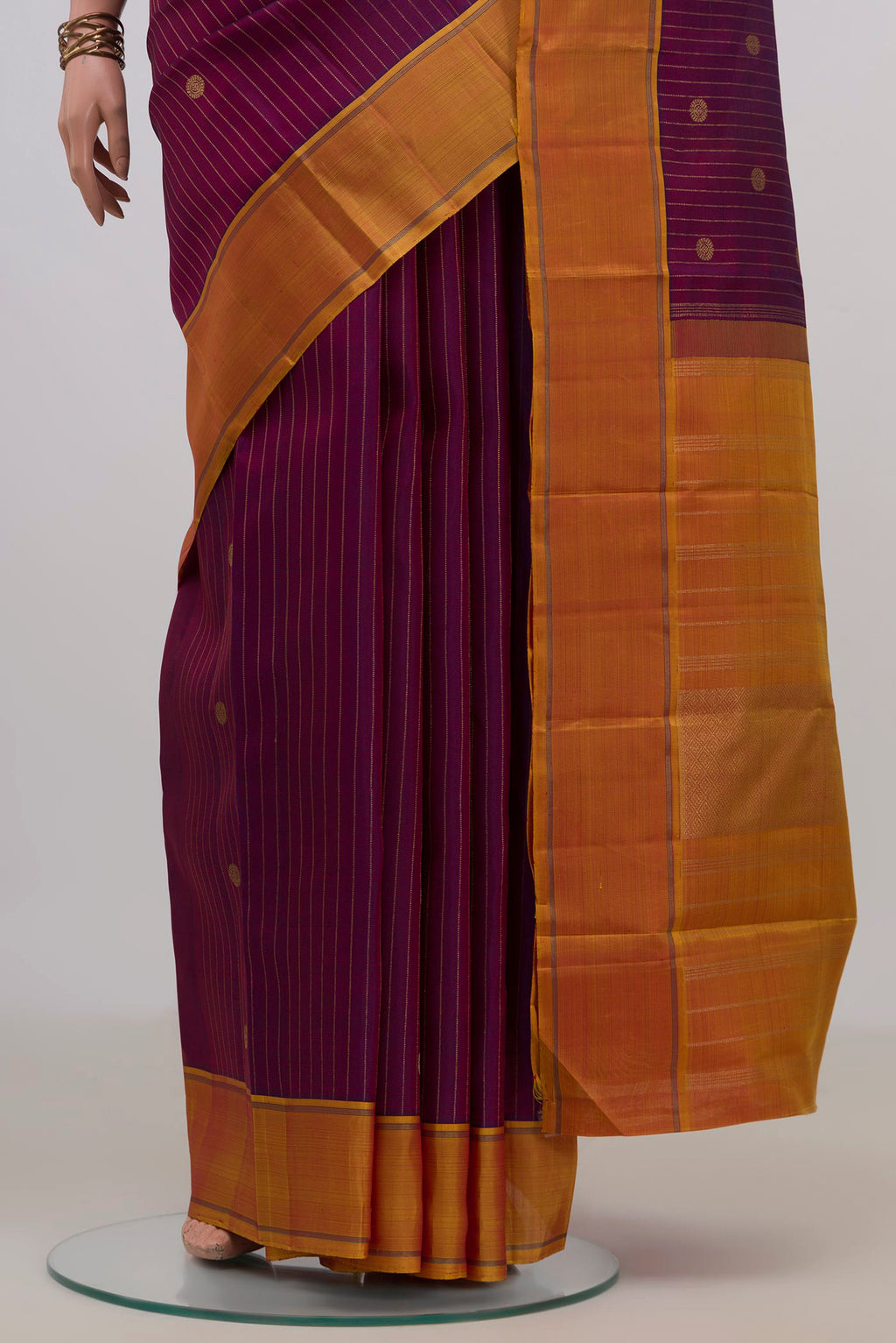 Pleats and pallu of Pure Silk Pure Zari Purple Kanchipuram Saree with Zari Butta on the body and Thin Zari Line. 