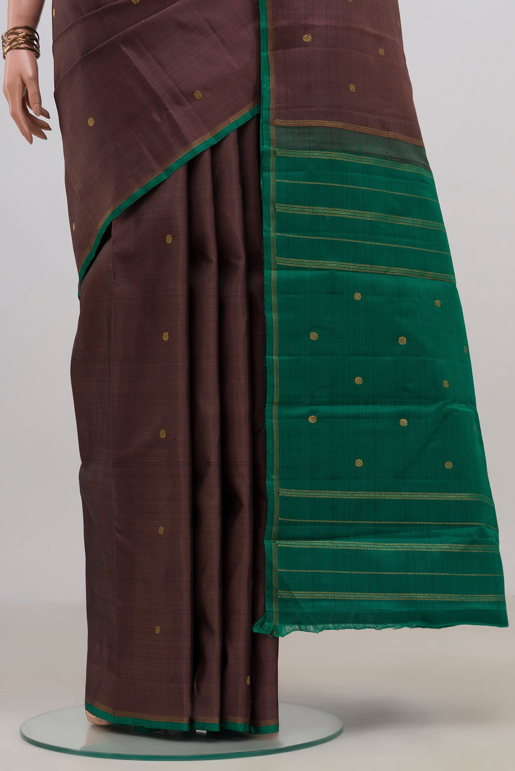 Pleats and pallu of Pure Silk Pure Zari Brown Kanjivaram Saree with Zari Butta on the body and Without Border. 