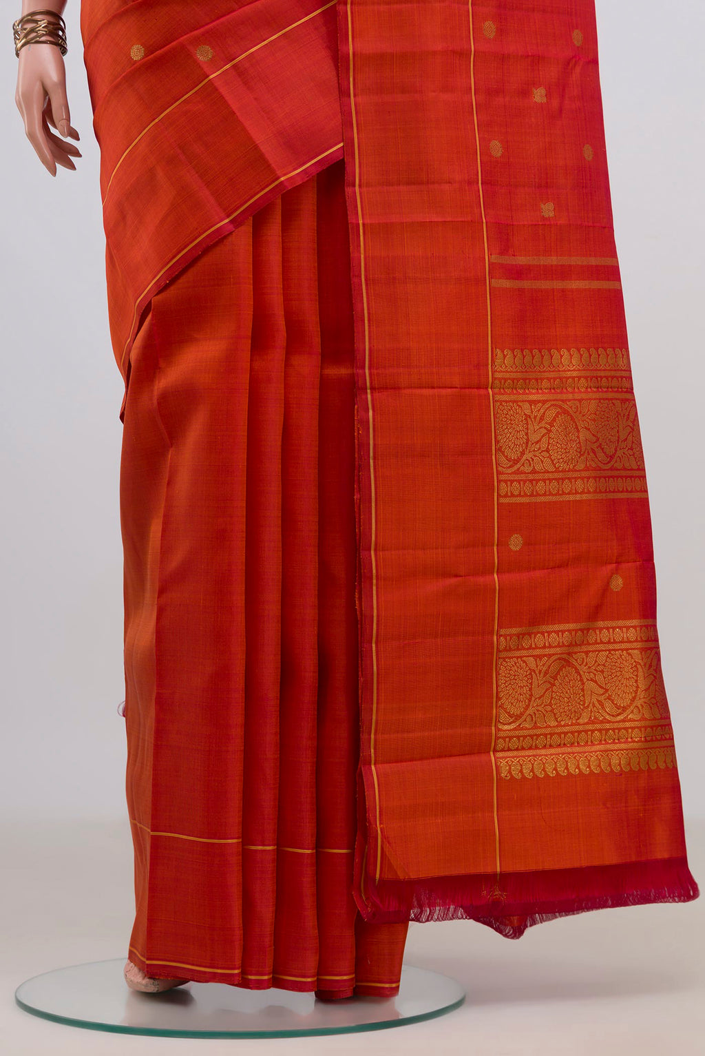 Pleats and pallu of Pure Silk Pure Zari Rust Kanjivaram Saree with Zari Butta on the body and Thin Zari Line. 
