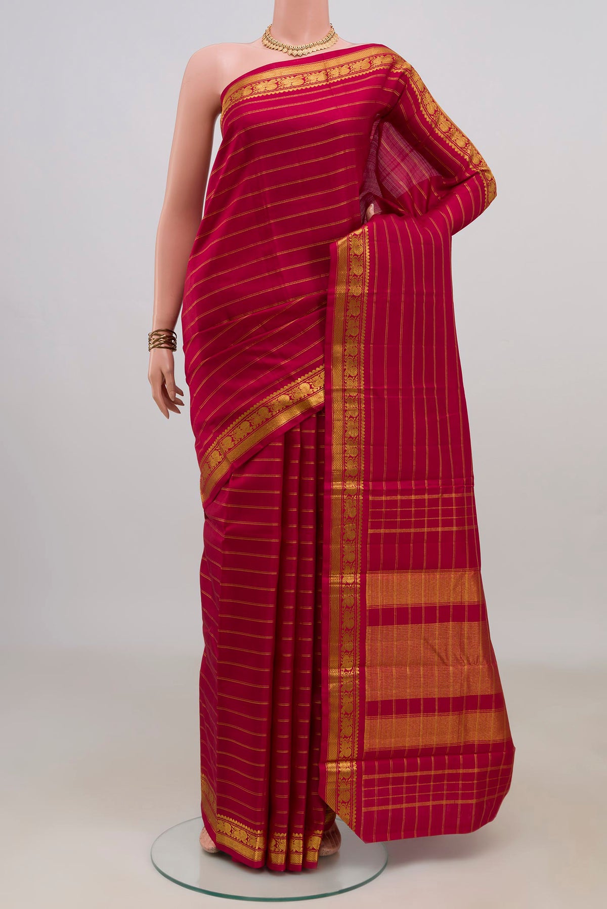 Pure Silk Maroon Kanchipuram Saree with Stripes on the body and Zari Border.  displayed on a mannequin