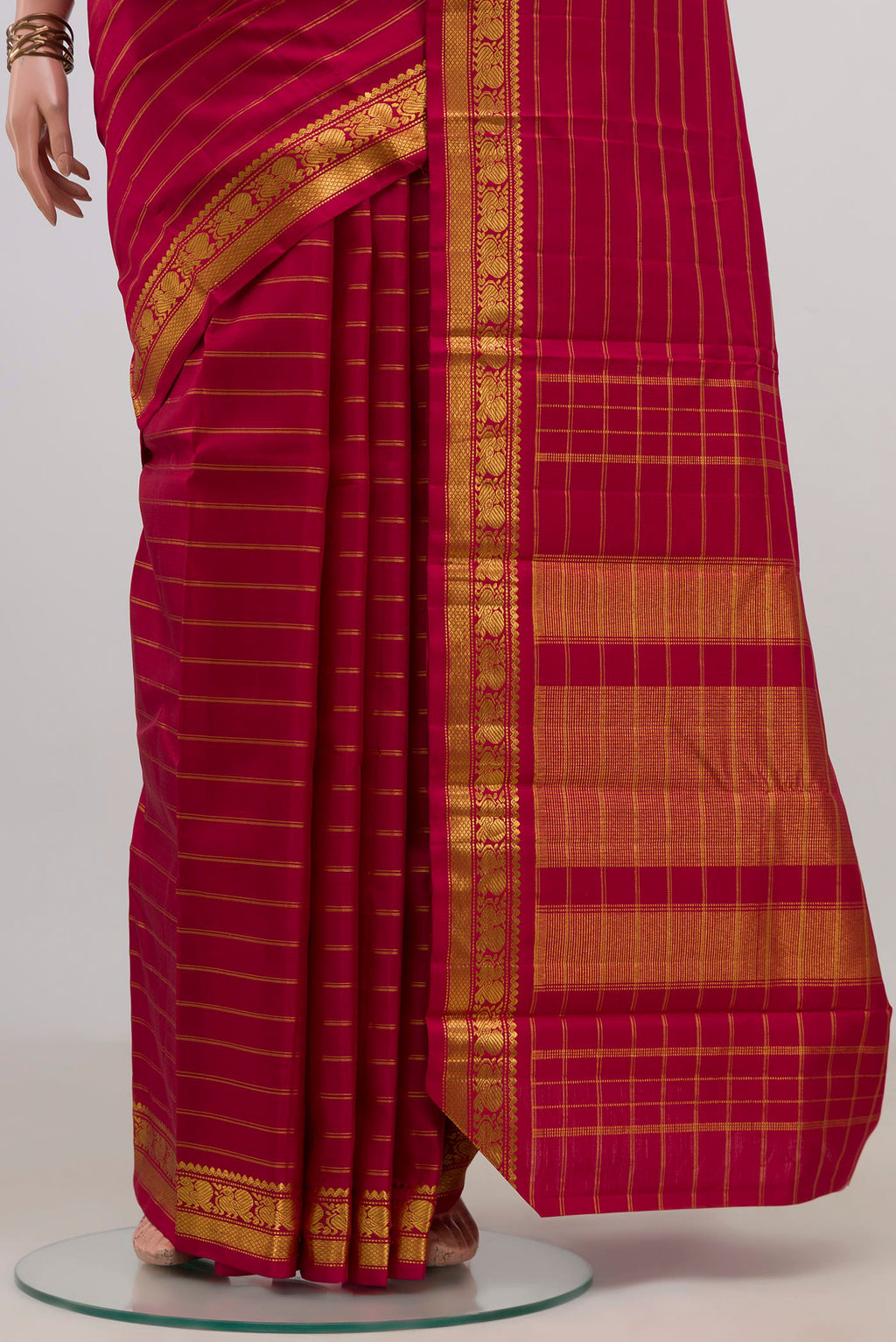 Pleats and pallu of Pure Silk Maroon Kanchipuram Saree with Stripes on the body and Zari Border. 
