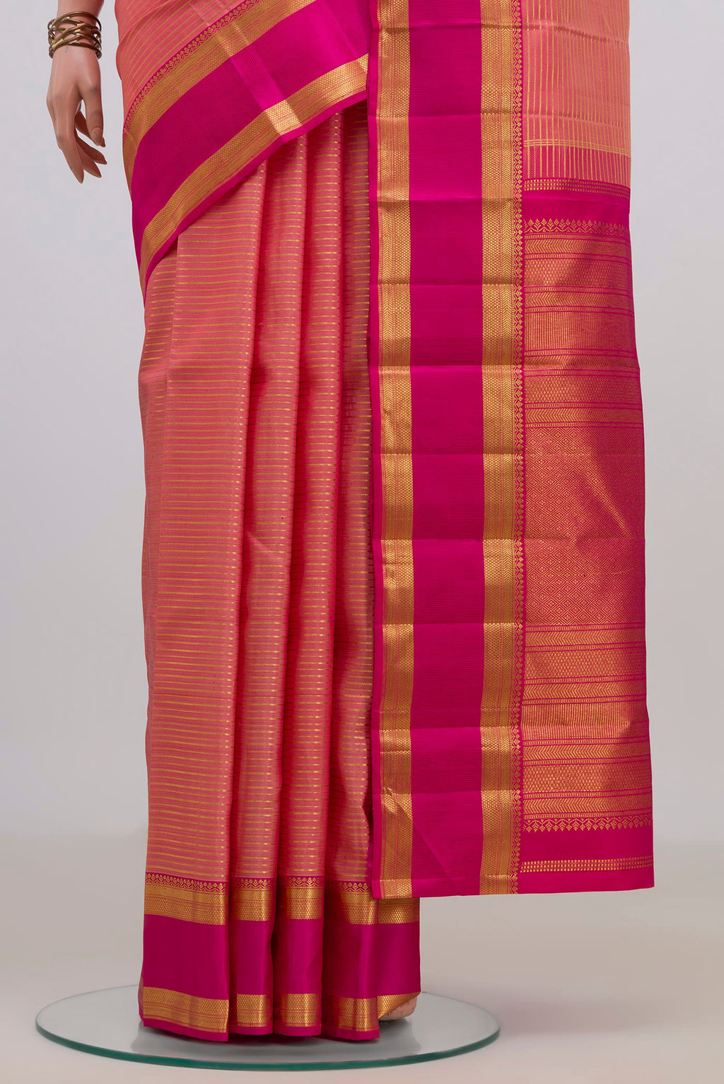 Pleats and pallu of Pure Silk Peach Kanjivaram Saree with Stripes on the body and Zari Border. 