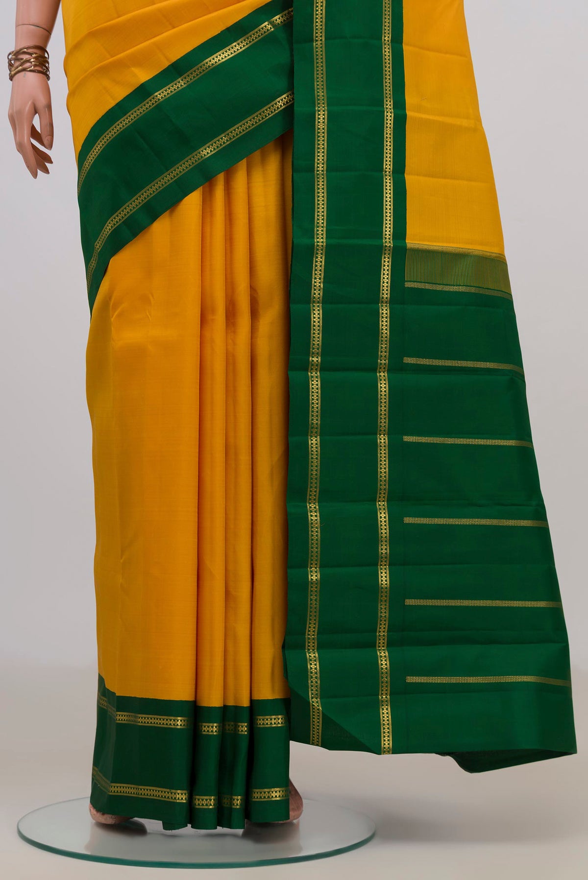 Pleats and pallu of Pure Silk Pure Zari Yellow Kanjivaram Saree with Plain Body and Zari Border. 