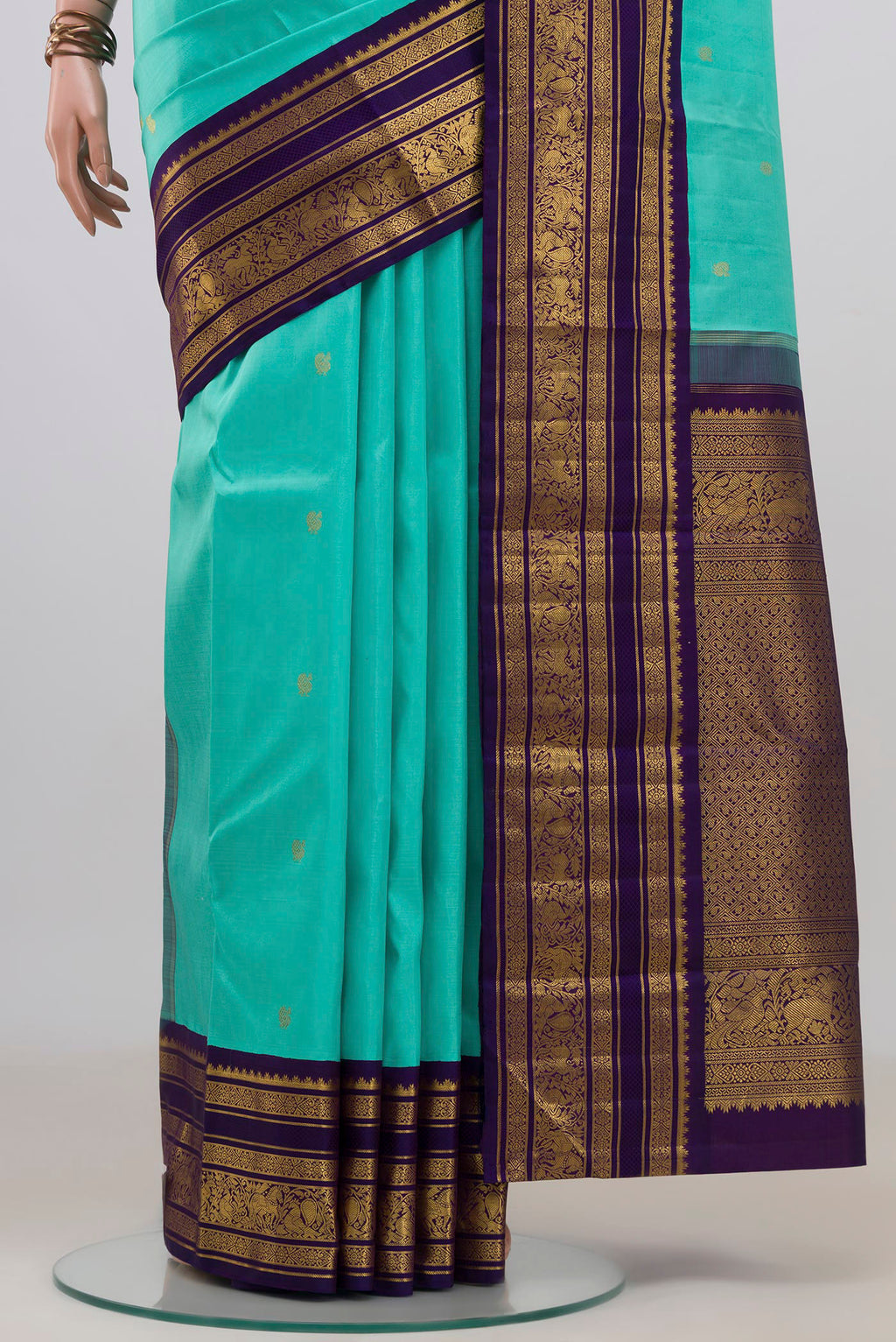 Pleats and pallu of Pure Silk Pure Zari Turquoise Kanchipuram Saree with Zari Butta on the body and Zari Border. 