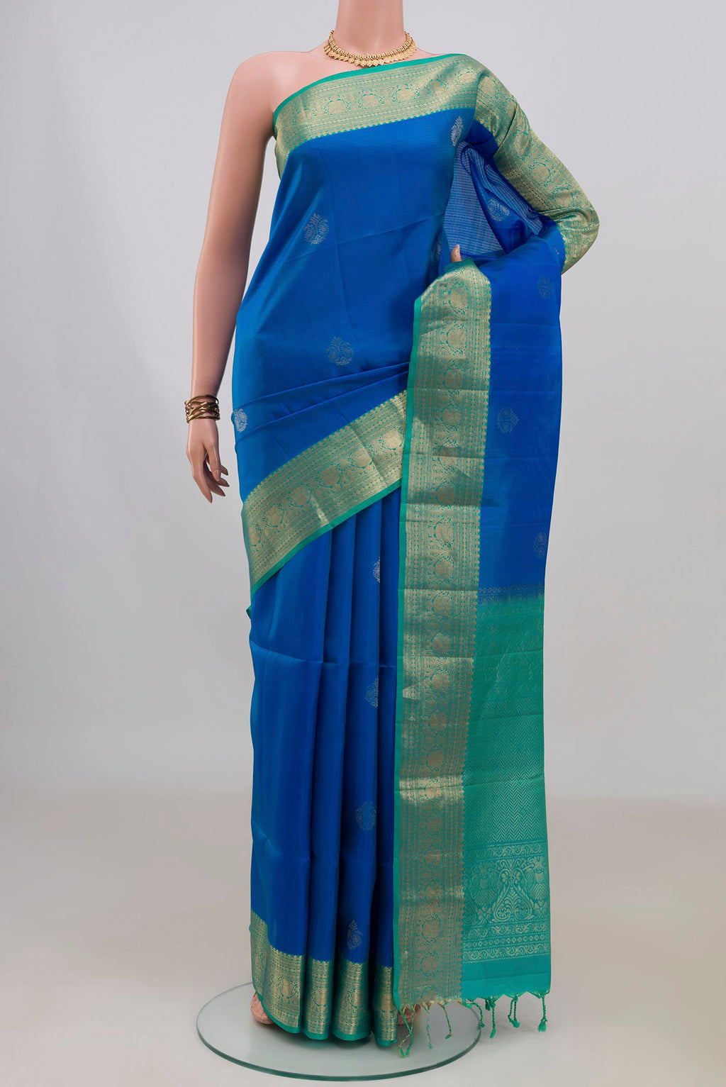 Pure Silk Royal Blue Soft Saree with Zari Butta on the body and Zari Border.  displayed on a mannequin