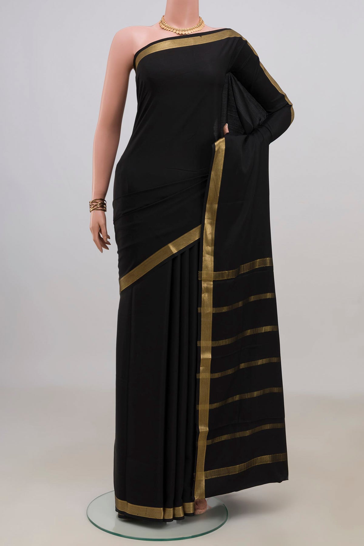 Black Crepe Saree with Plain Body and Zari Border.  displayed on a mannequin