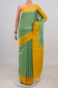 Pure Silk Pista Green Soft Saree with Checked design on the body and Fancy Border.  displayed on a mannequin