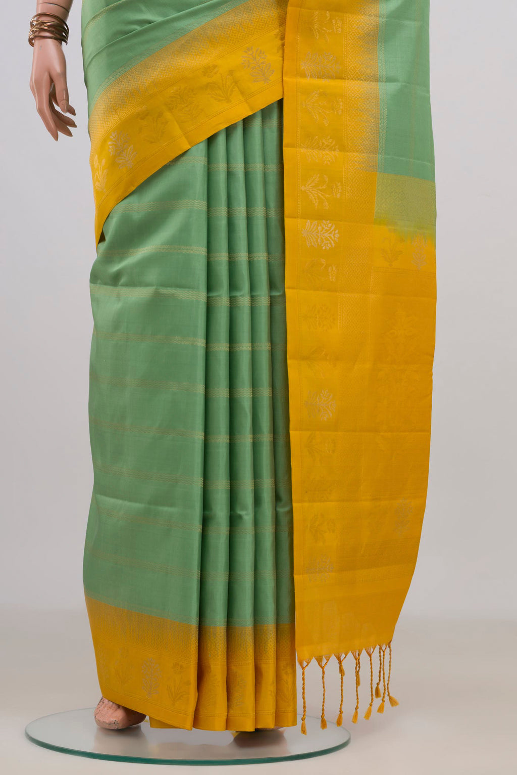 Pleats and pallu of Pure Silk Pista Green Soft Saree with Checked design on the body and Fancy Border. 