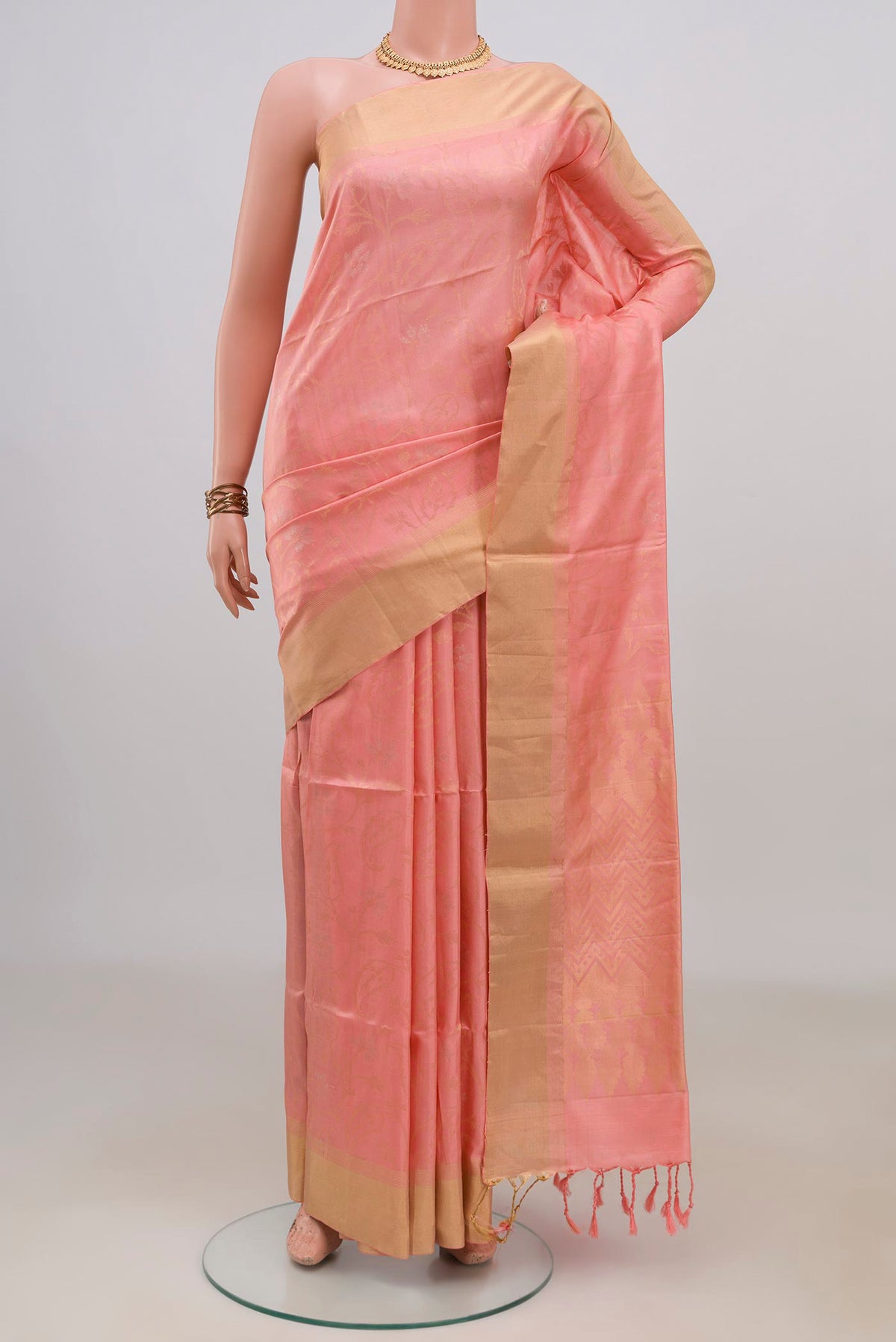 Pure Silk Peach Soft Saree with Stripes on the body and Zari Border.  displayed on a mannequin