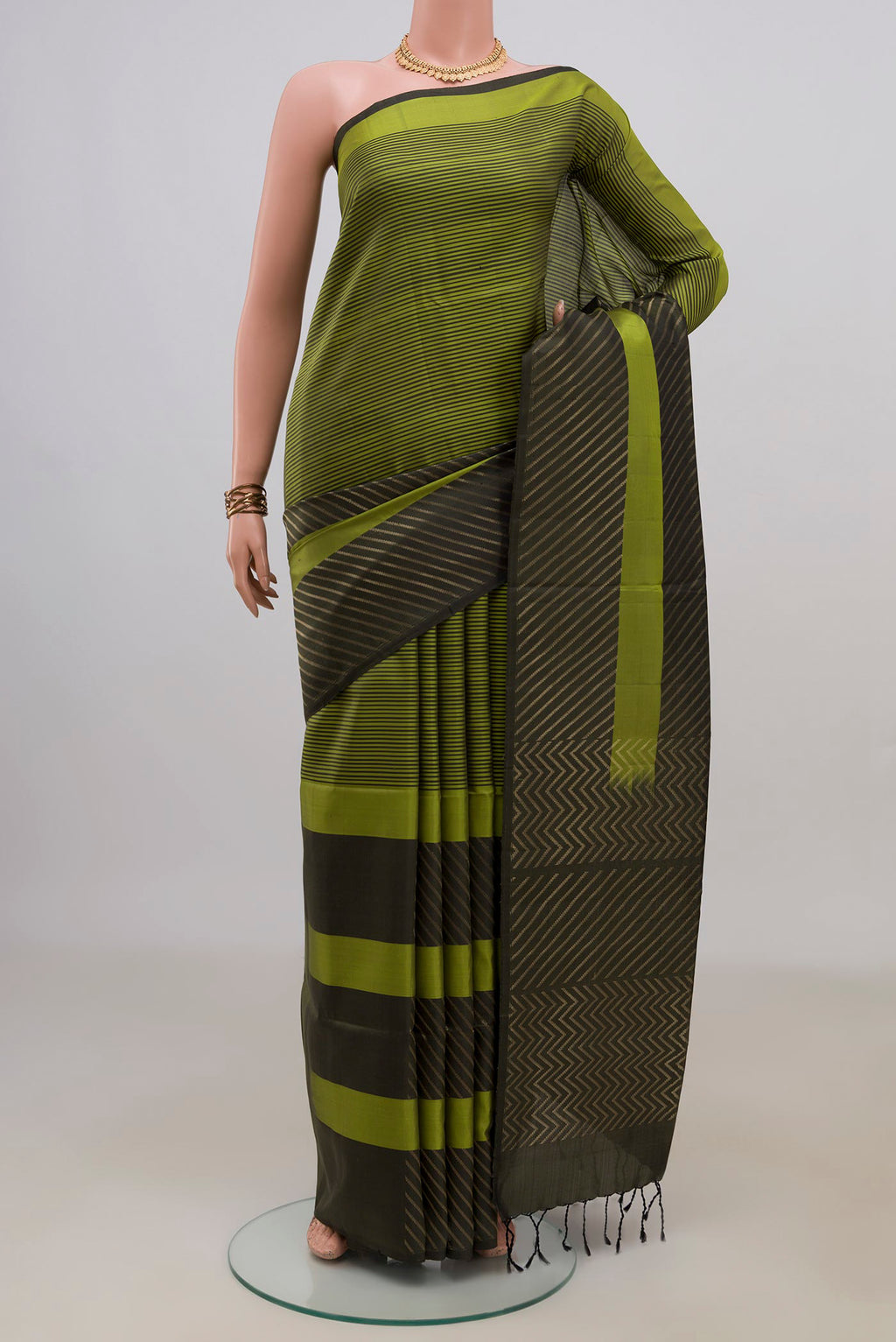 Pure Silk Green Soft Saree with Fancy on the body and Without Border.  displayed on a mannequin