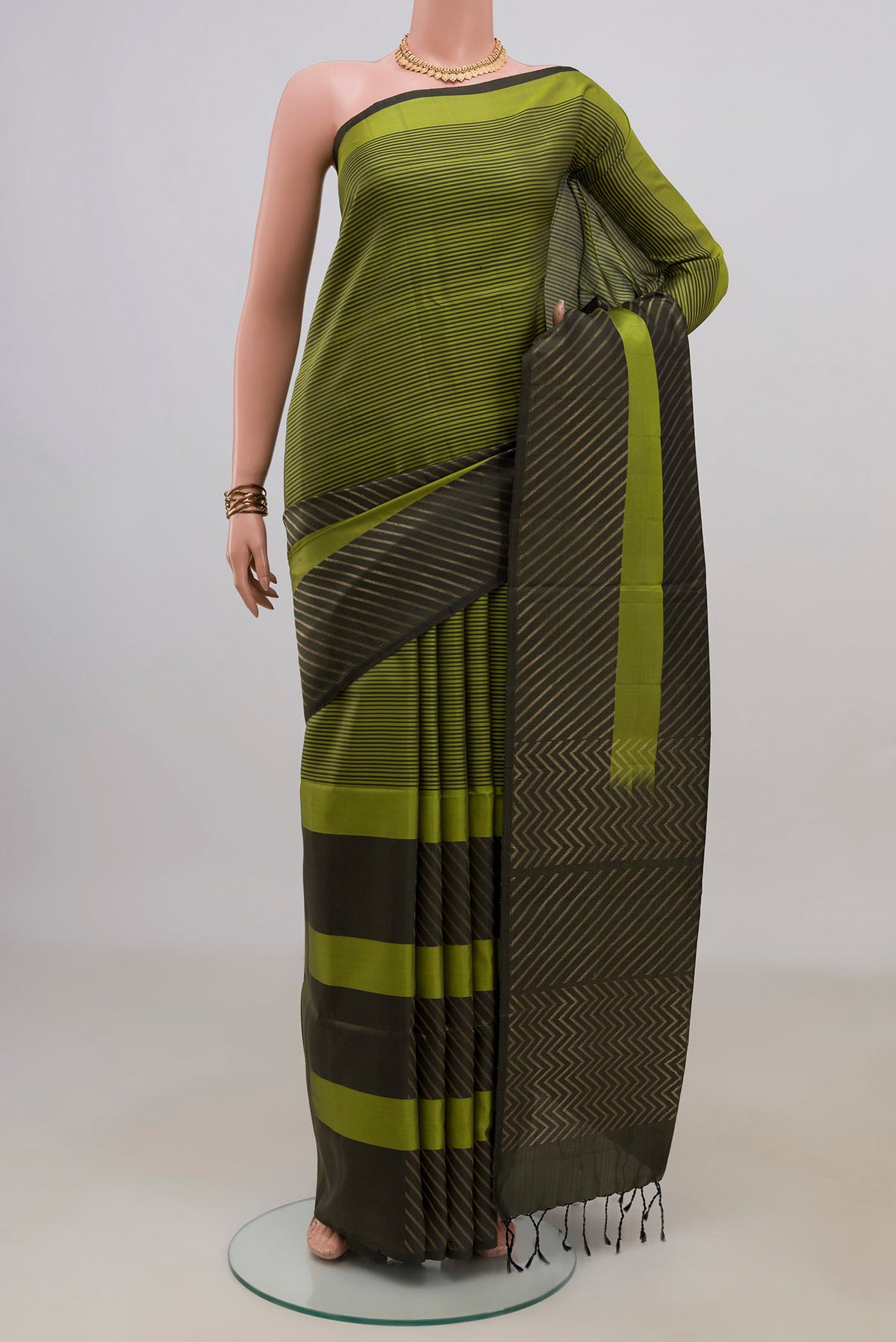 Pure Silk Green Soft Saree with Fancy on the body and Without Border.  displayed on a mannequin