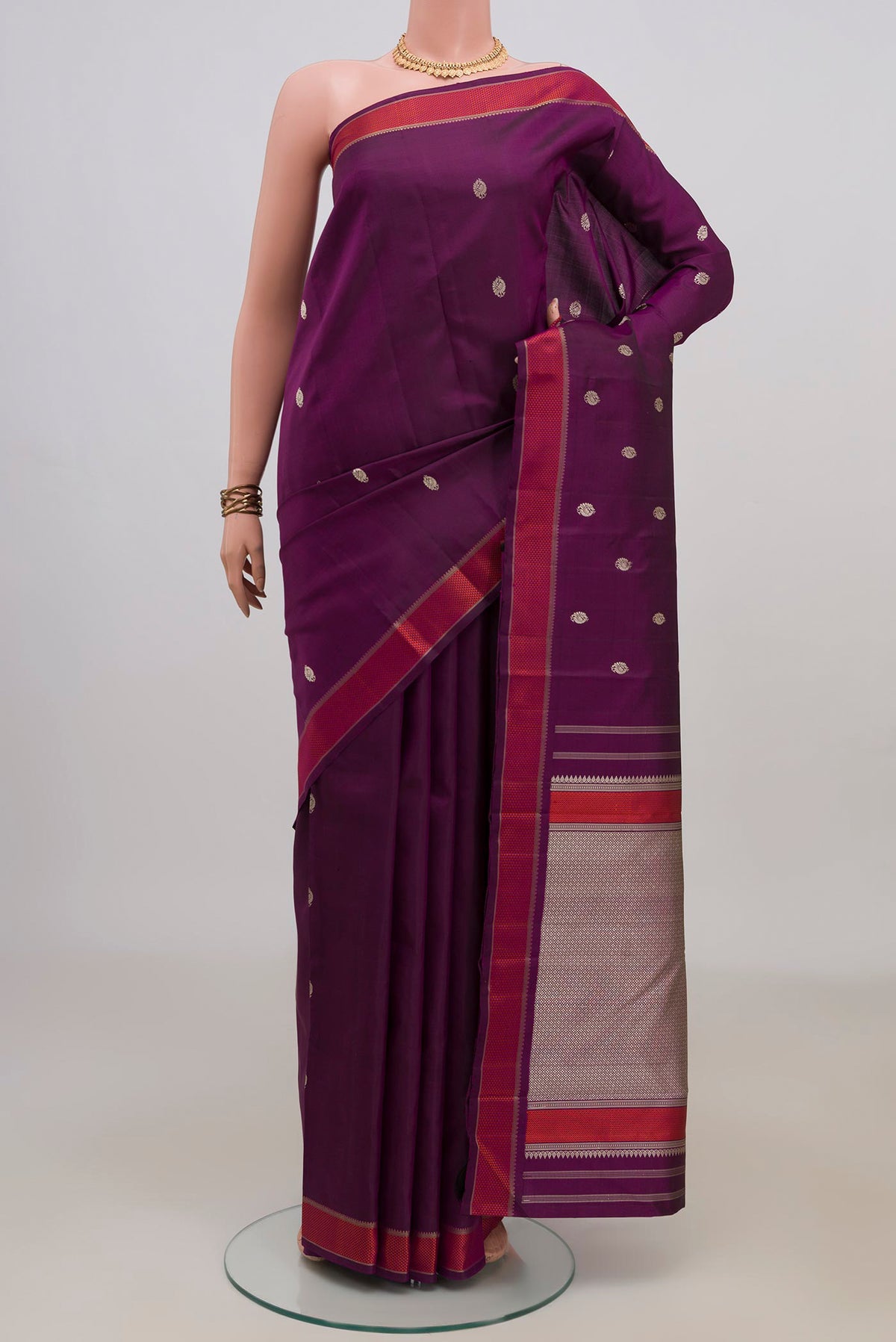 Pure Silk Purple Kanjivaram Saree with Thread Butta on the body and Thread Border.  displayed on a mannequin