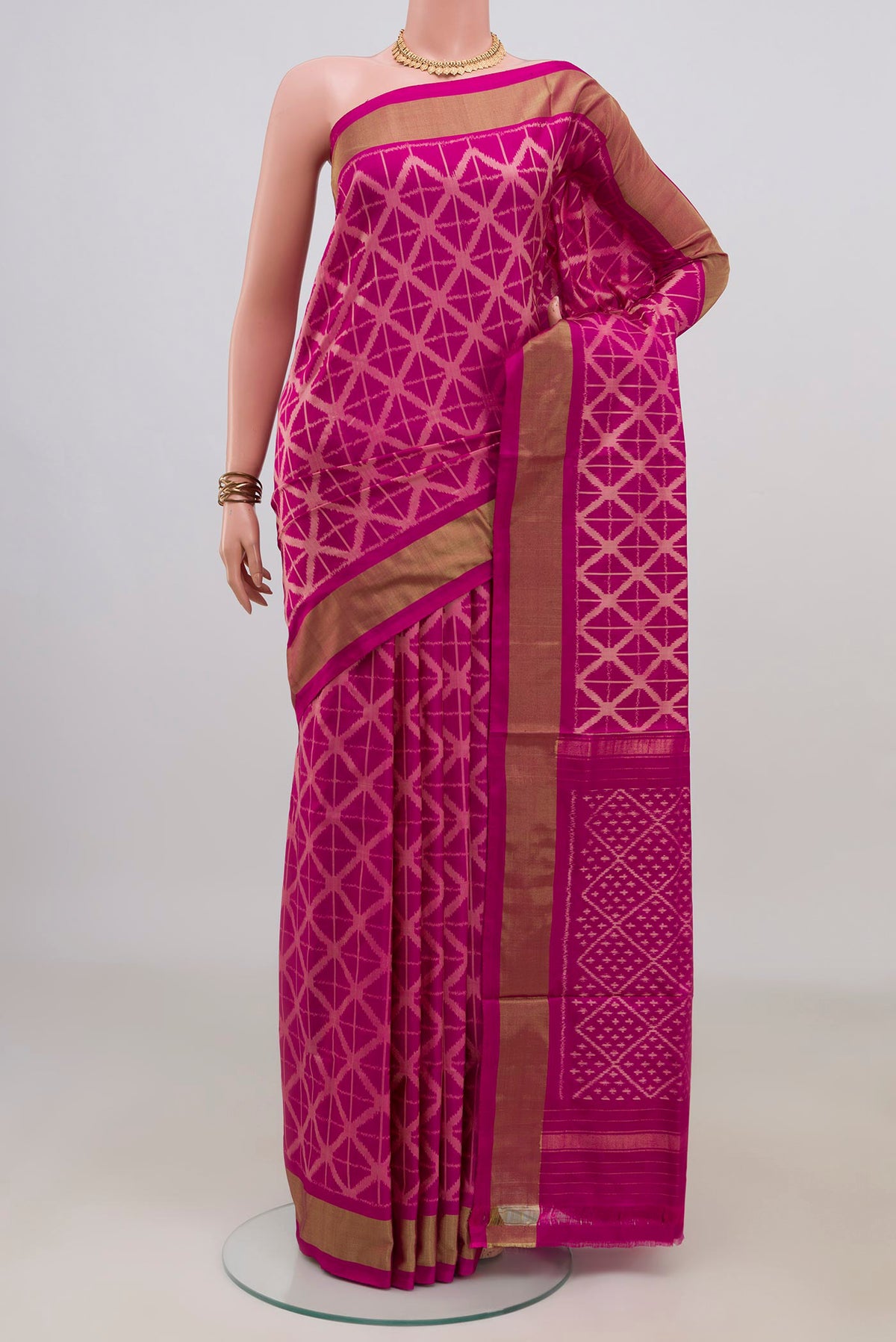 Pure Silk Magenta Pochampally Saree with Ikat design on the body and Zari Border.  displayed on a mannequin
