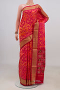 Pure Silk Orange Pochampally Saree with Ikat design on the body and Zari Border.  displayed on a mannequin