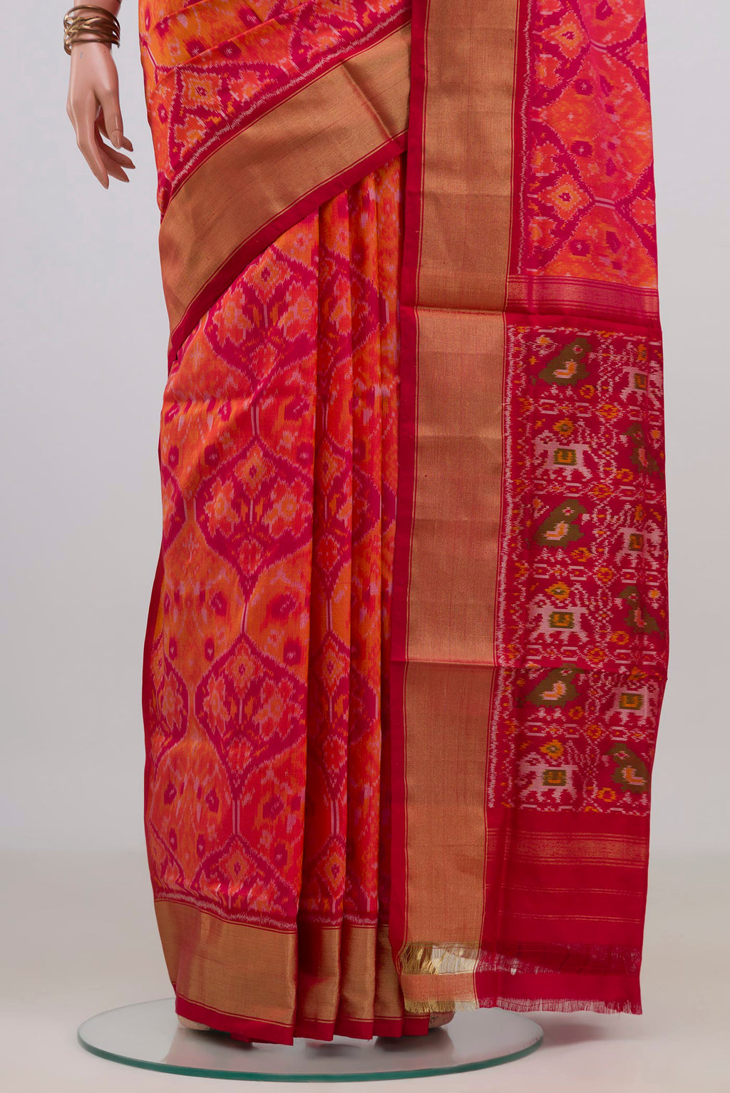 Pleats and pallu of Pure Silk Orange Pochampally Saree with Ikat design on the body and Zari Border. 