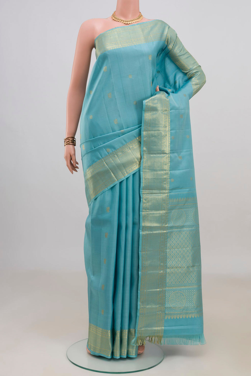Pure Silk Light Blue Kanjivaram Saree with Zari Butta on the body and Zari Border.  displayed on a mannequin
