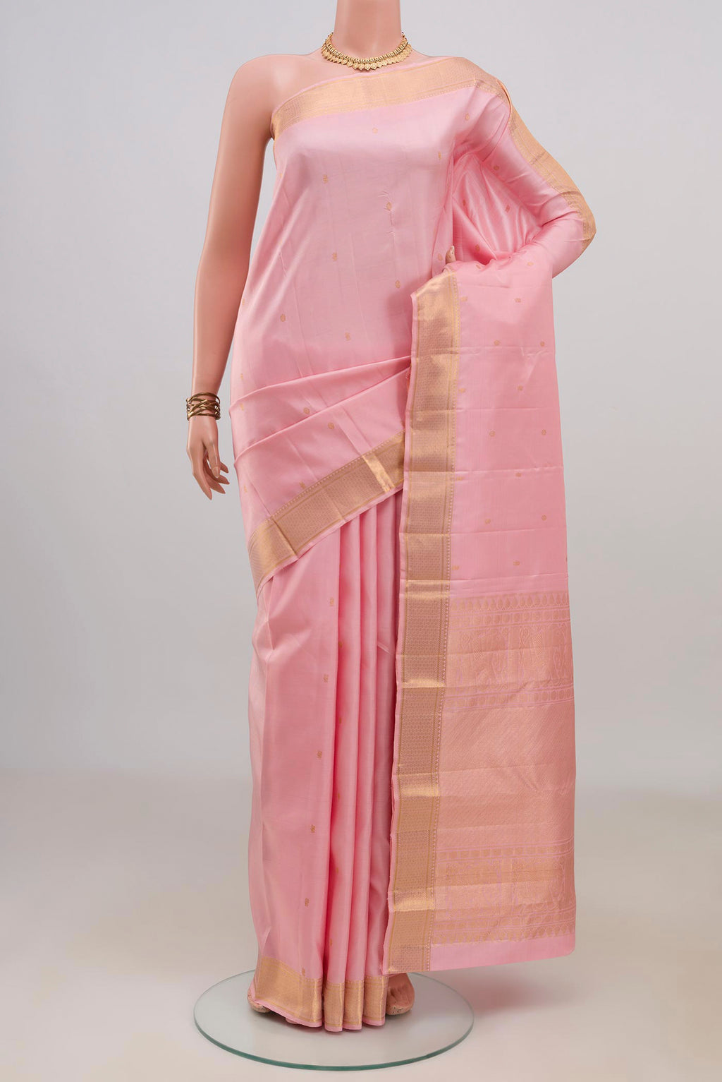 Pure Silk Rose pink Kanjivaram Saree with Zari Butta on the body and Zari Border.  displayed on a mannequin