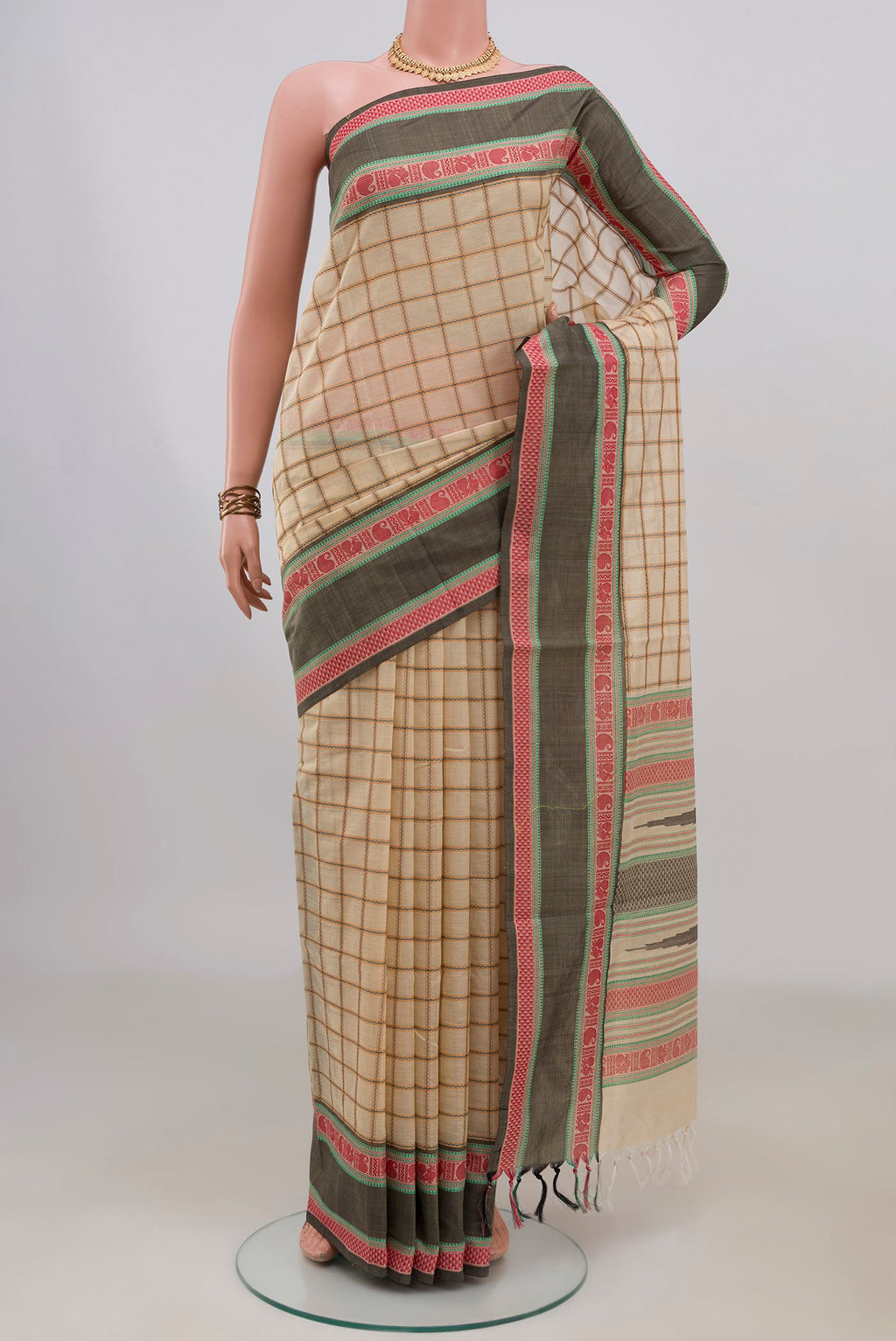 Cream Silk Cotton Saree with Checked design on the body and Thread Border.  displayed on a mannequin
