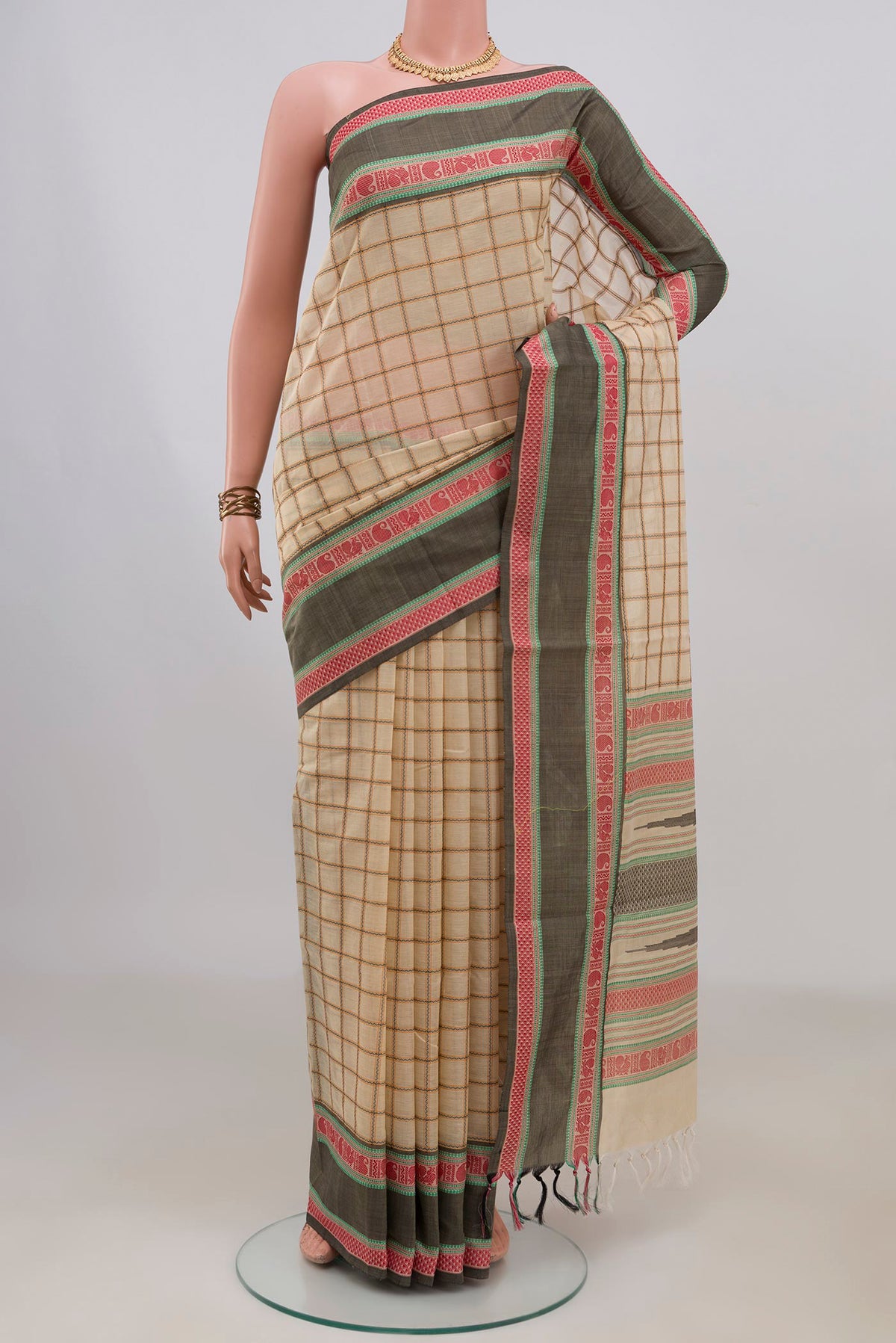Cream Silk Cotton Saree with Checked design on the body and Thread Border.  displayed on a mannequin