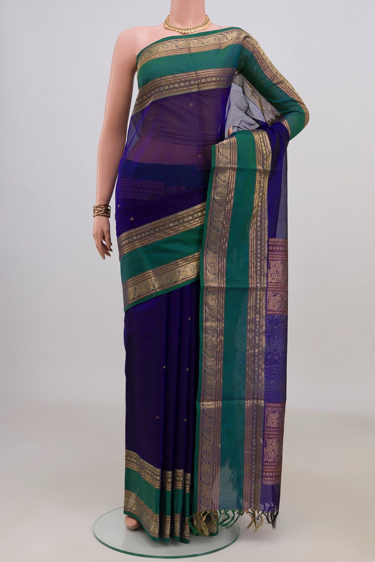 Royal Blue Silk Cotton Saree with Thread Butta on the body and Zari Border.  displayed on a mannequin