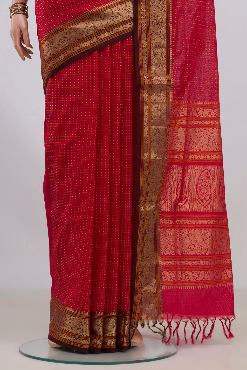 Pleats and pallu of Red Silk Cotton Saree with Checked design on the body and Zari Border. 