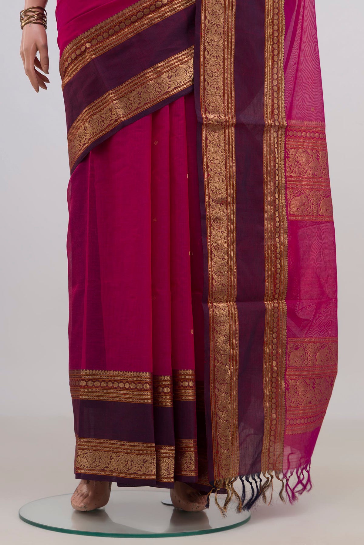 Pleats and pallu of Rani Pink Silk Cotton Saree with Zari Butta on the body and Zari Border. 