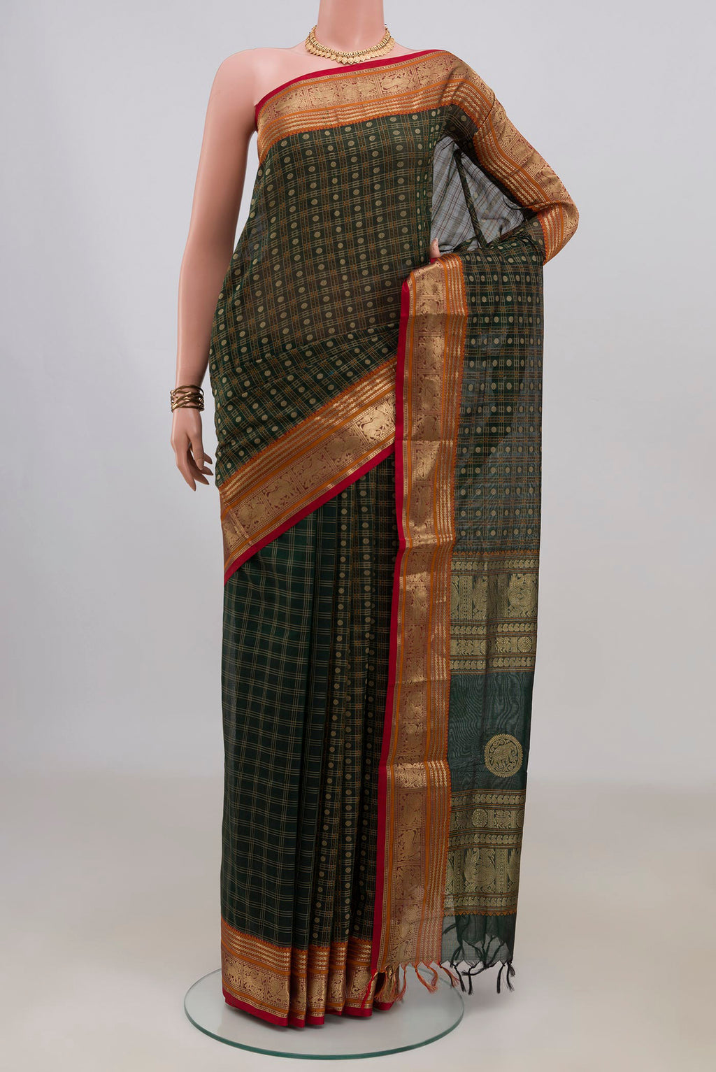 Bottle Green Silk Cotton Saree with Checked design on the body and Zari Border.  displayed on a mannequin