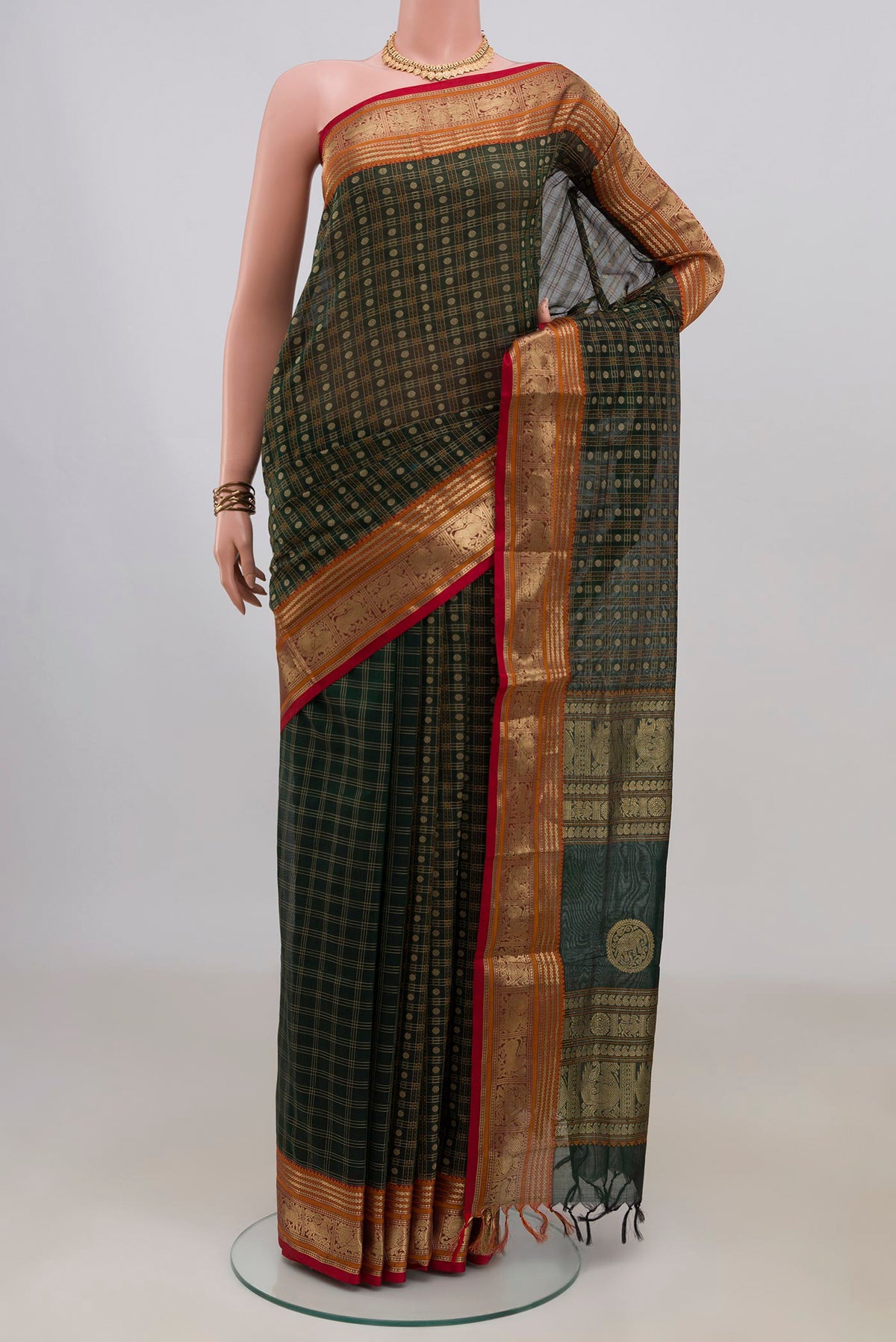 Bottle Green Silk Cotton Saree with Checked design on the body and Zari Border.  displayed on a mannequin