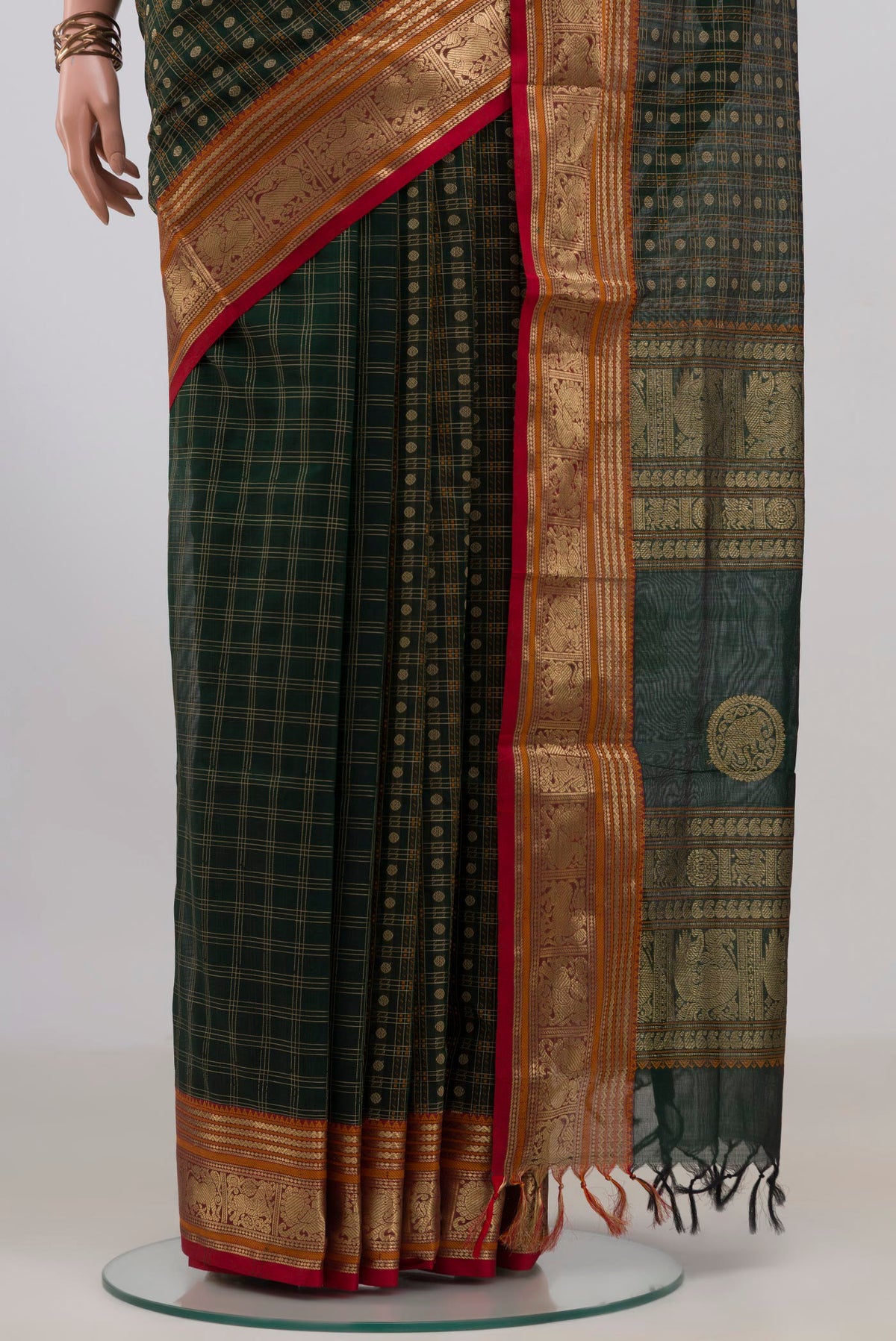 Pleats and pallu of Bottle Green Silk Cotton Saree with Checked design on the body and Zari Border. 