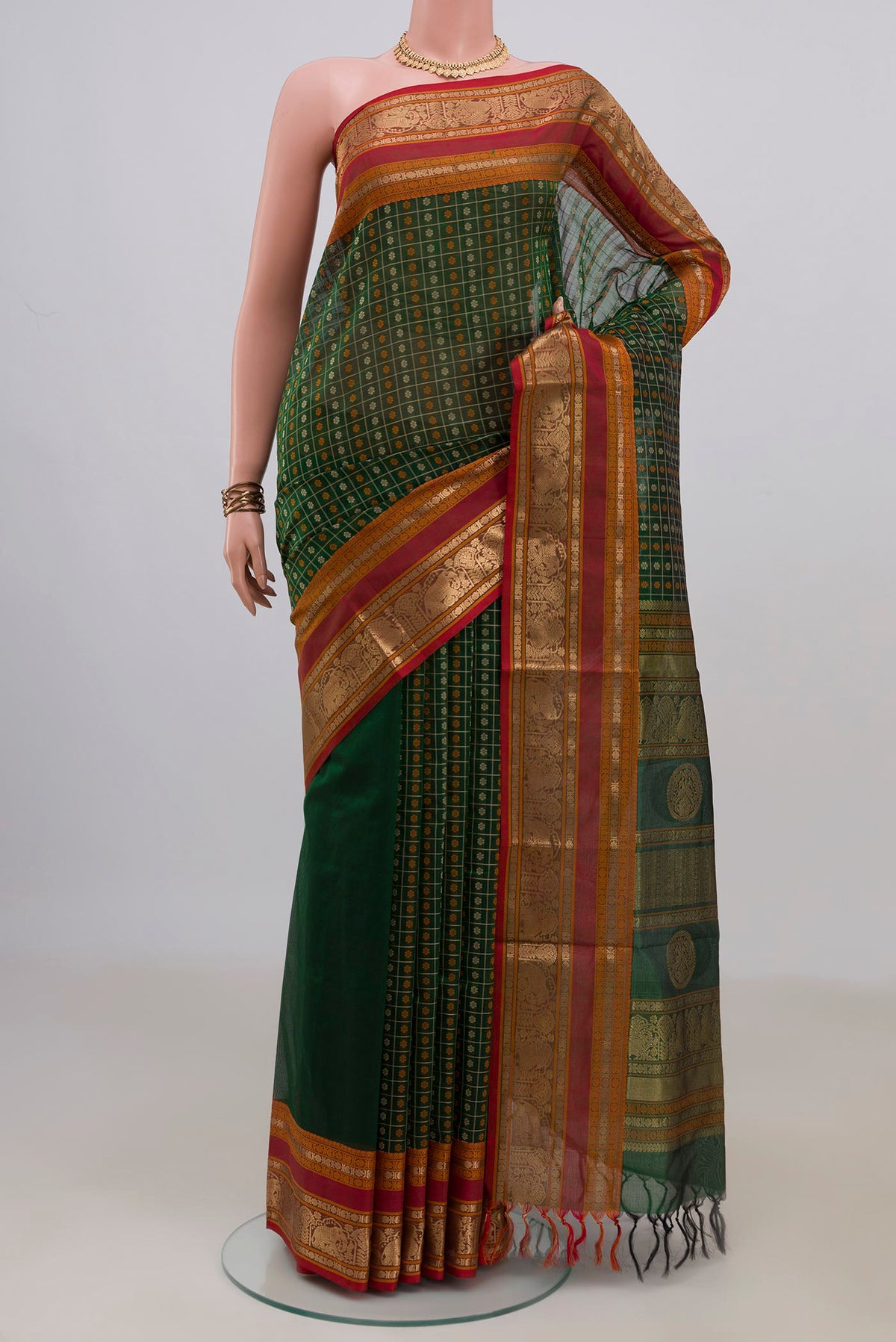 Green Silk Cotton Saree with Checked design on the body and Zari Border.  displayed on a mannequin