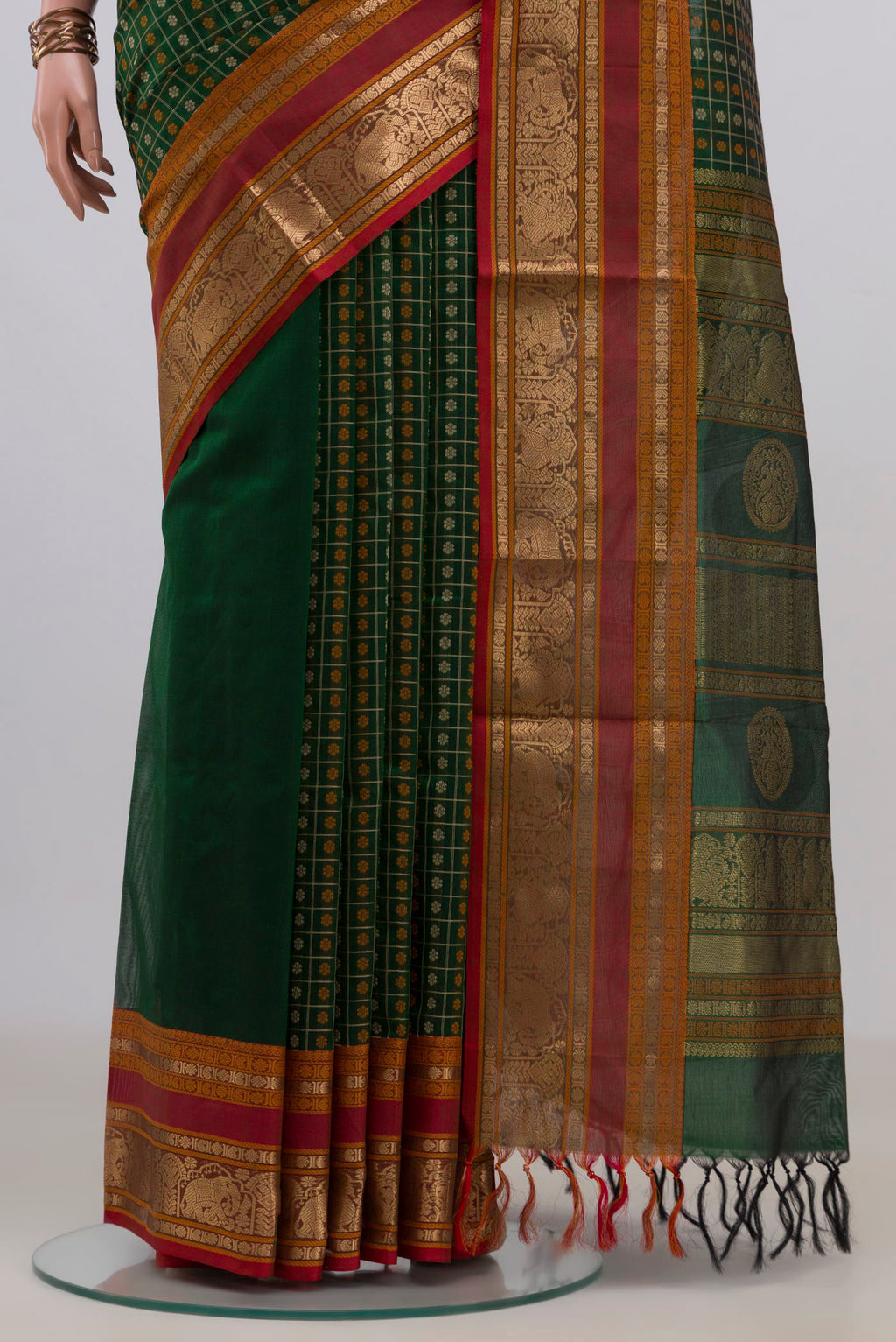 Pleats and pallu of Green Silk Cotton Saree with Checked design on the body and Zari Border. 