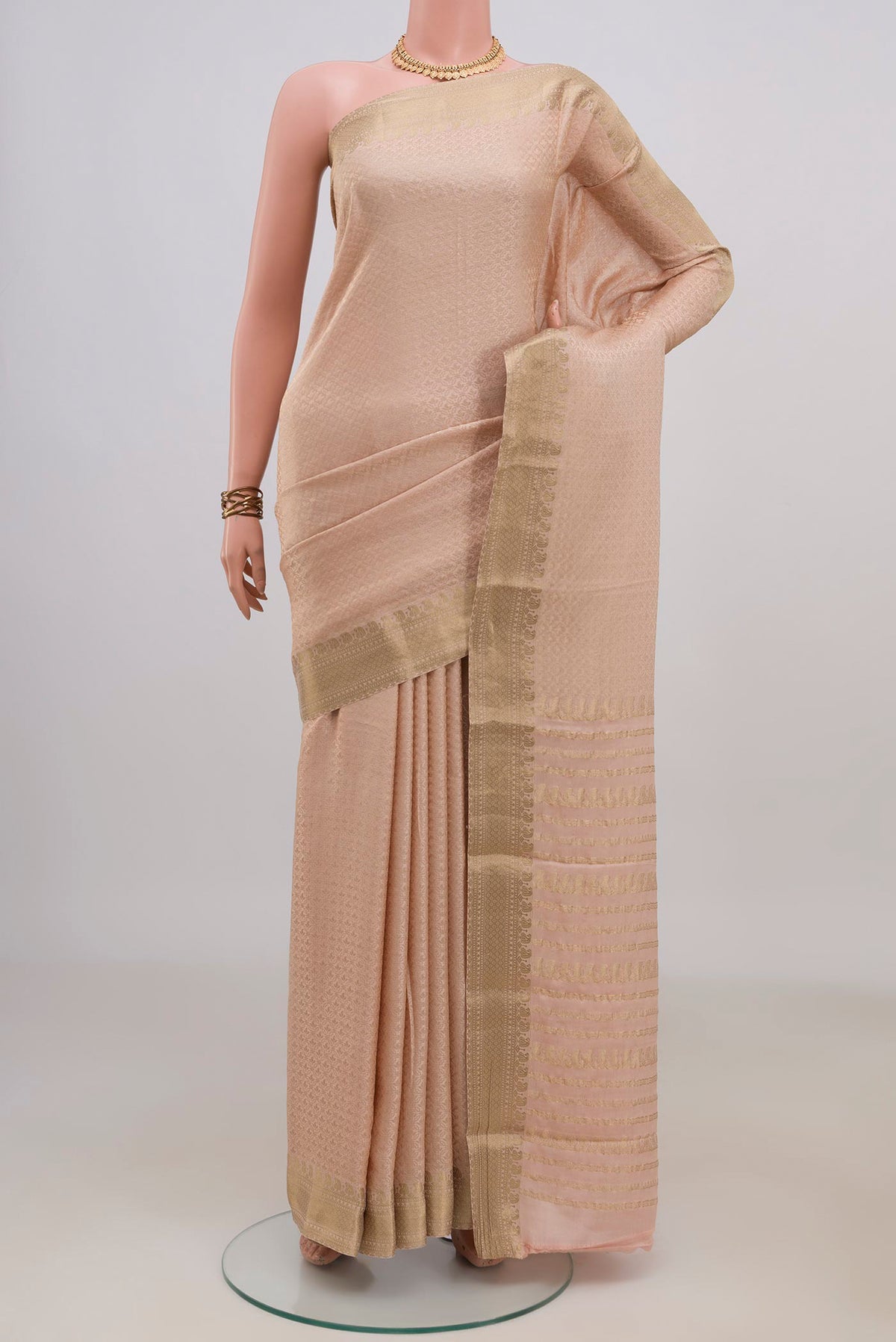 Peach Mysore Crepe Saree with Zari Brocade on the body and Zari Border.  displayed on a mannequin