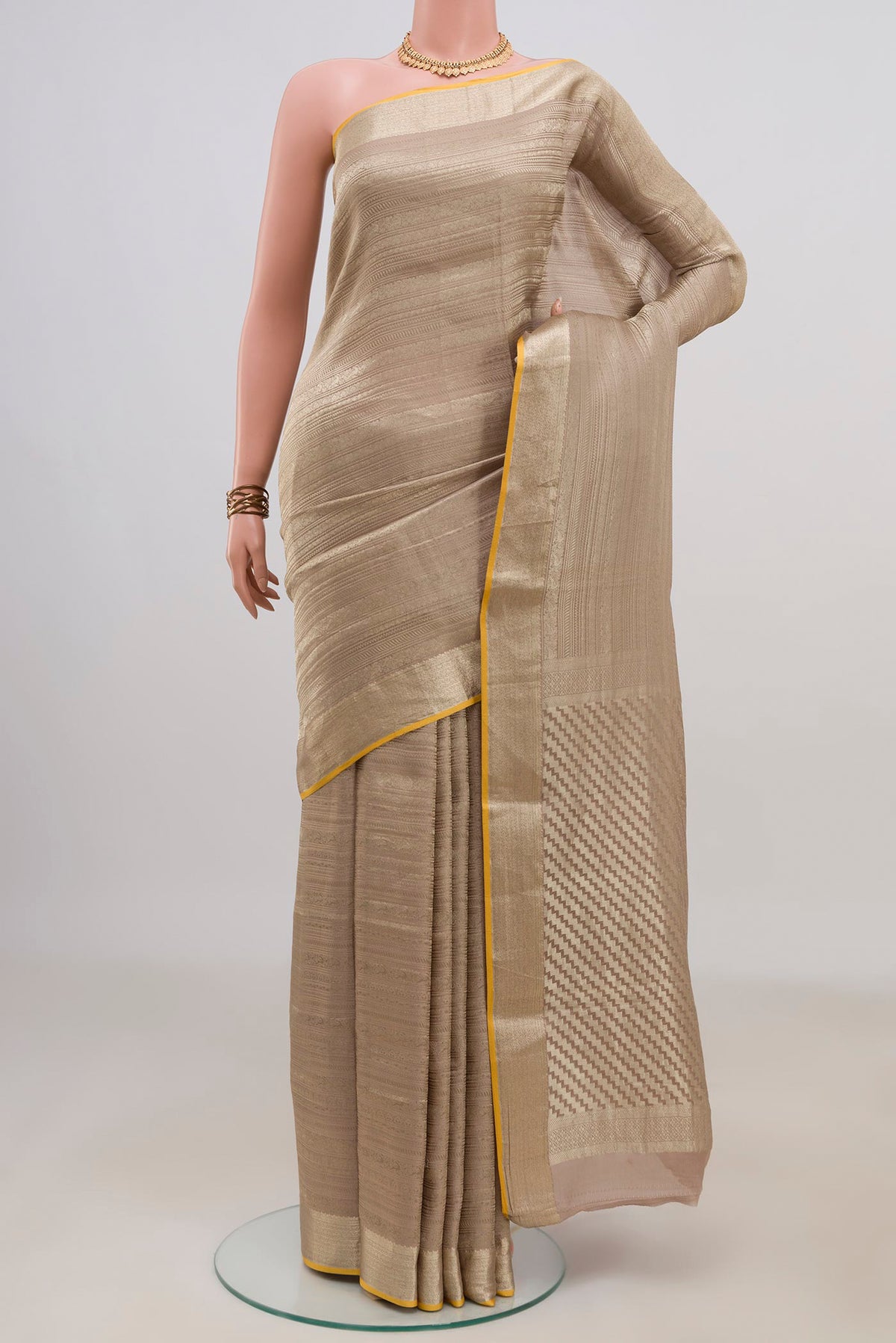 Rose Gold Mysore Crepe Saree with Zari Brocade on the body and Fancy Border.  displayed on a mannequin