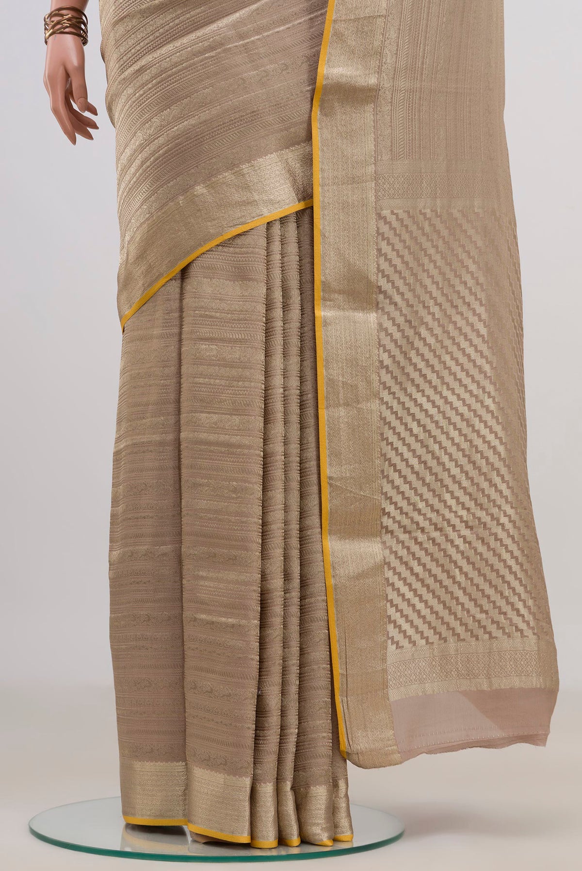 Pleats and pallu of Rose Gold Mysore Crepe Saree with Zari Brocade on the body and Fancy Border. 