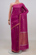 Magenta Tussar Saree with Zari Butta on the body and Zari Border.  displayed on a mannequin