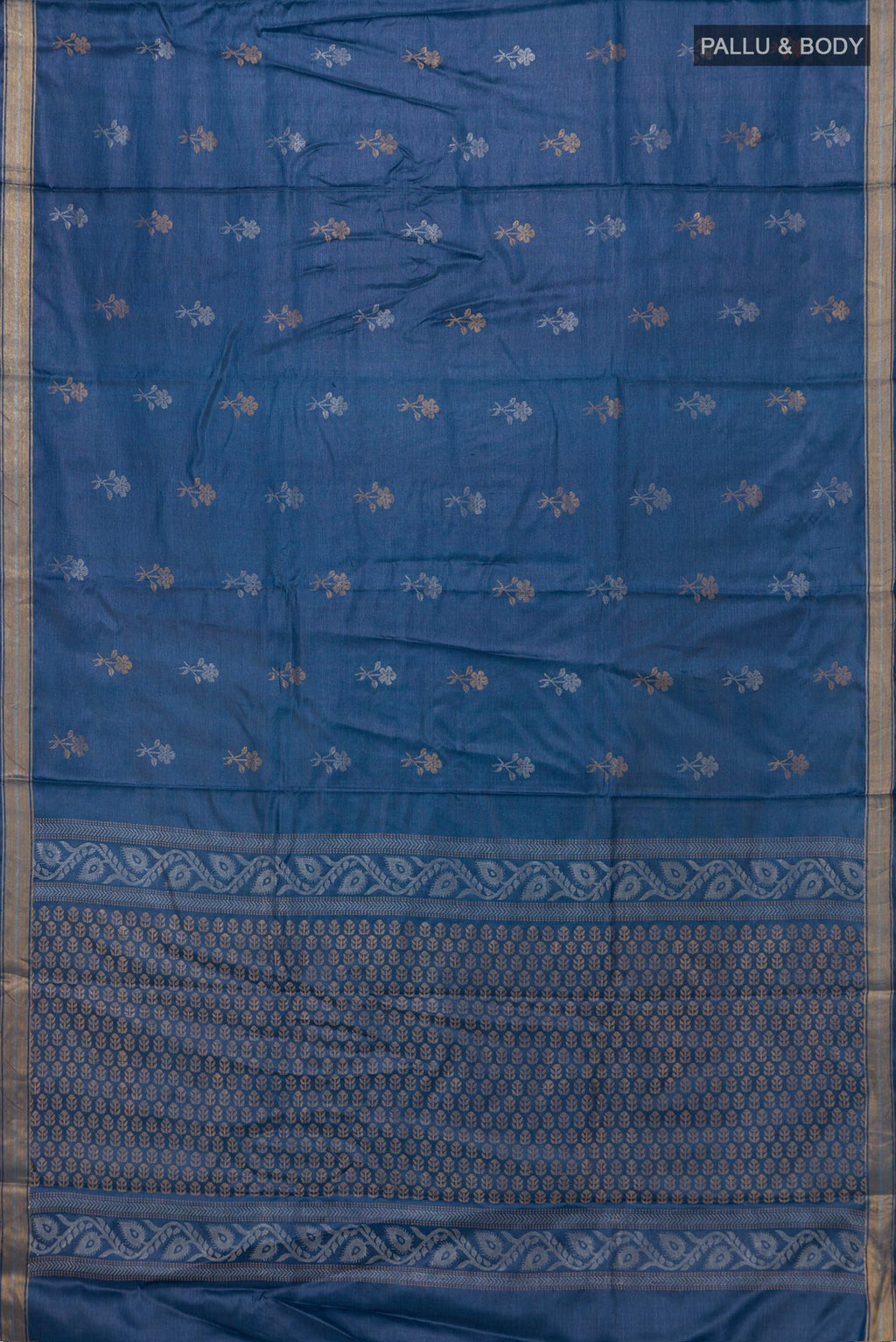 Flat view of Blue Tussar Saree with Zari Butta on the body and Zari Border. 