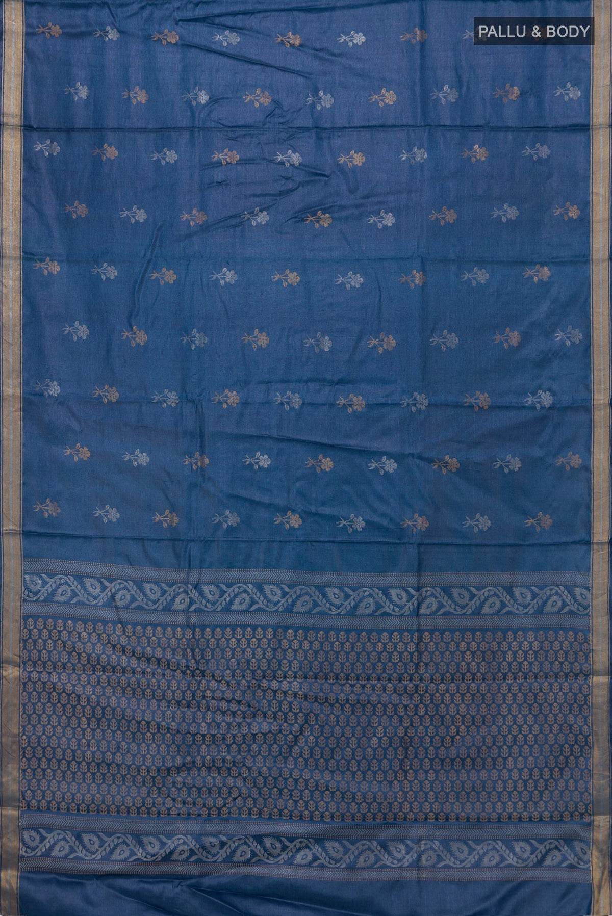Flat view of Blue Tussar Saree with Zari Butta on the body and Zari Border. 